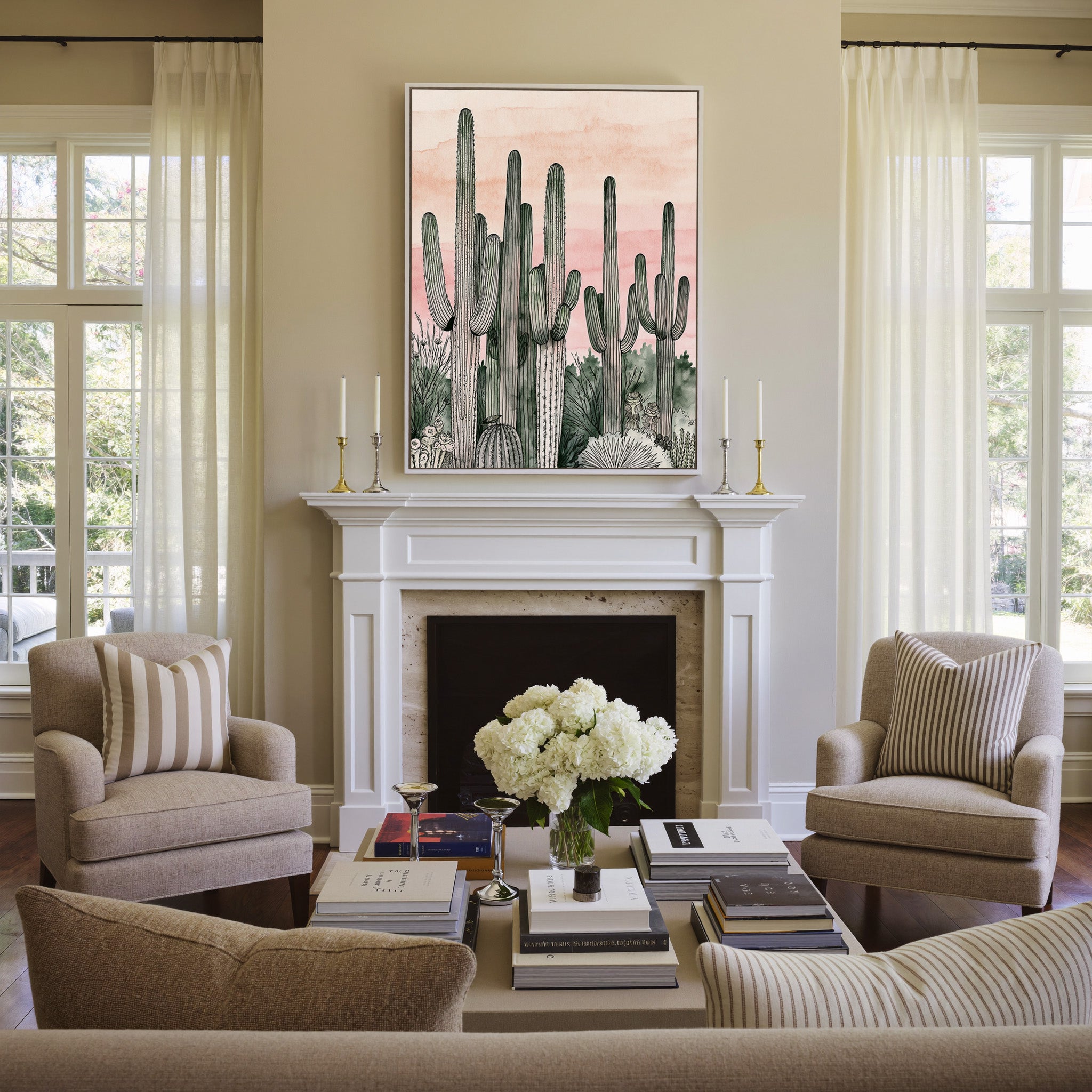 pink dusk sky with tall saguaro columns canvas wall art in a white frame above a mantel