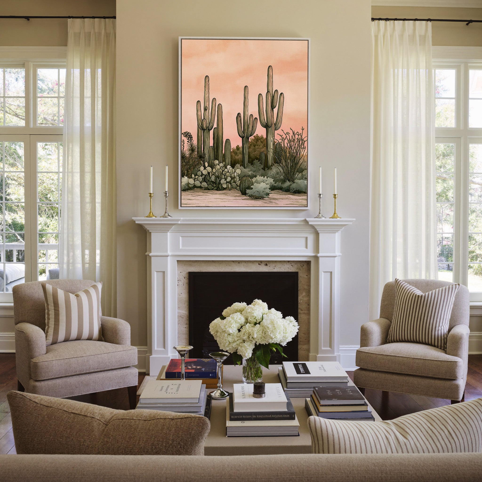 pink dusk desert cactus garden canvas wall art in a white frame above a mantel