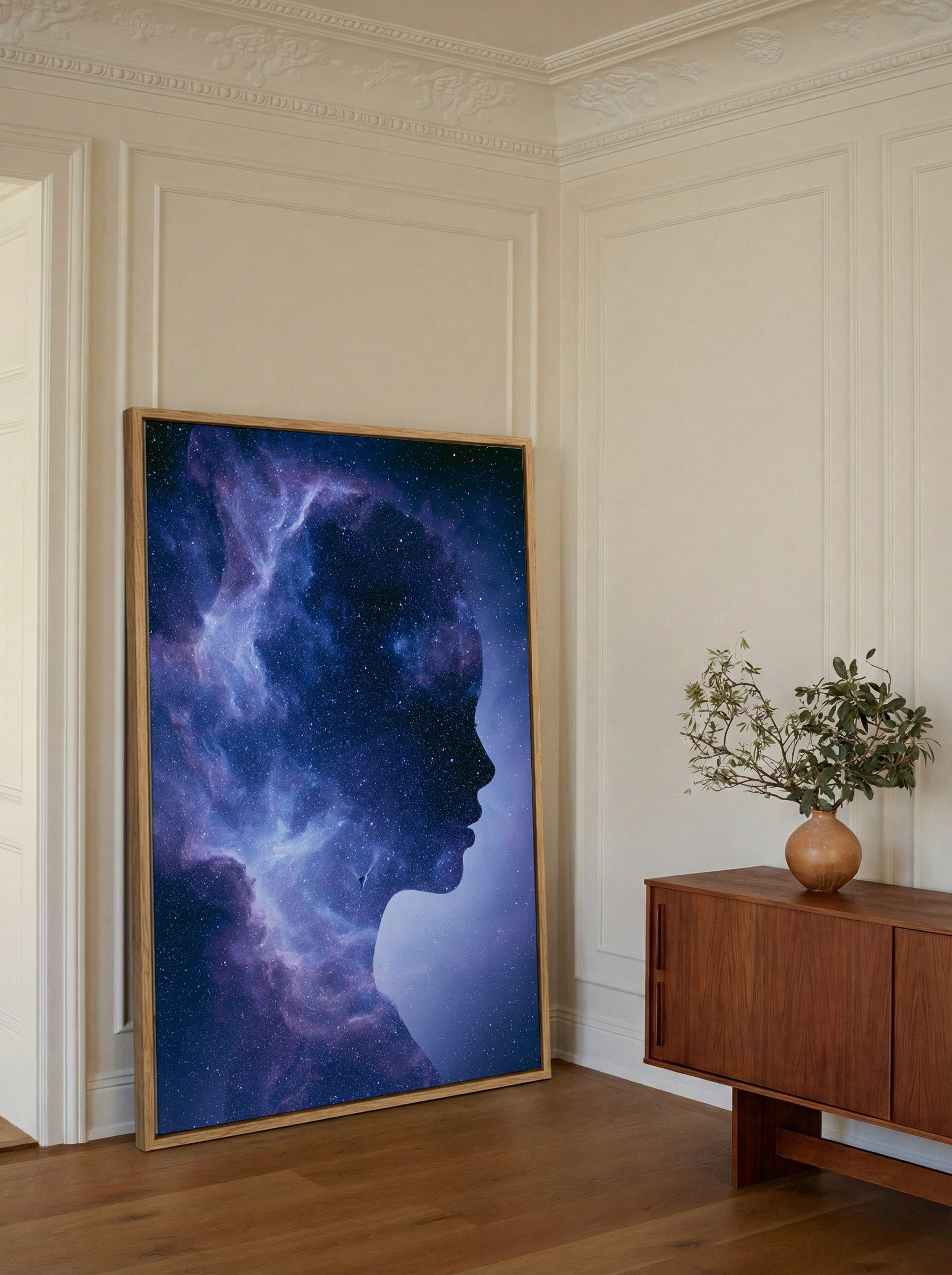 woman silhouette filled with swirling blue and canvas wall art in an oak frame in a styled room setting