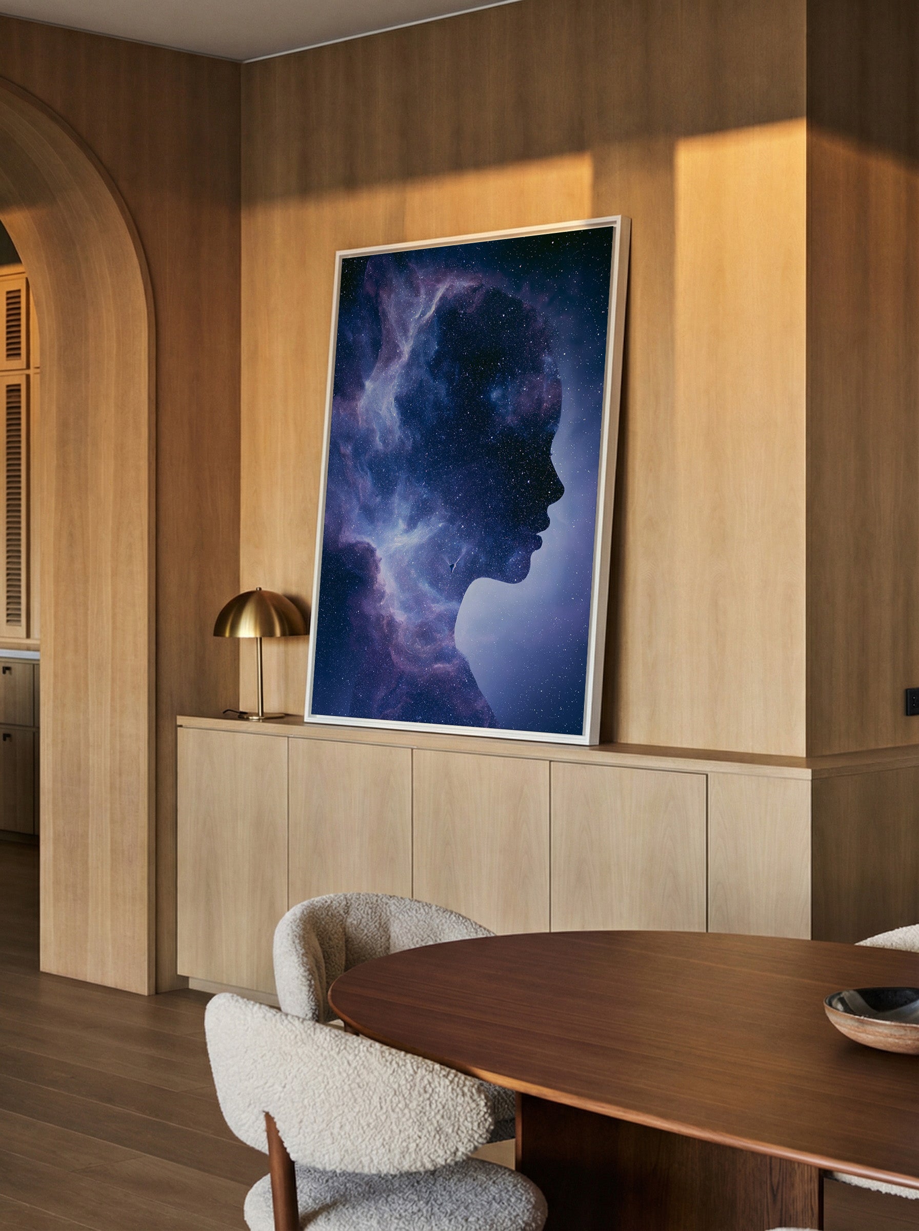 woman silhouette filled with swirling blue and canvas wall art in a white frame in a styled room setting