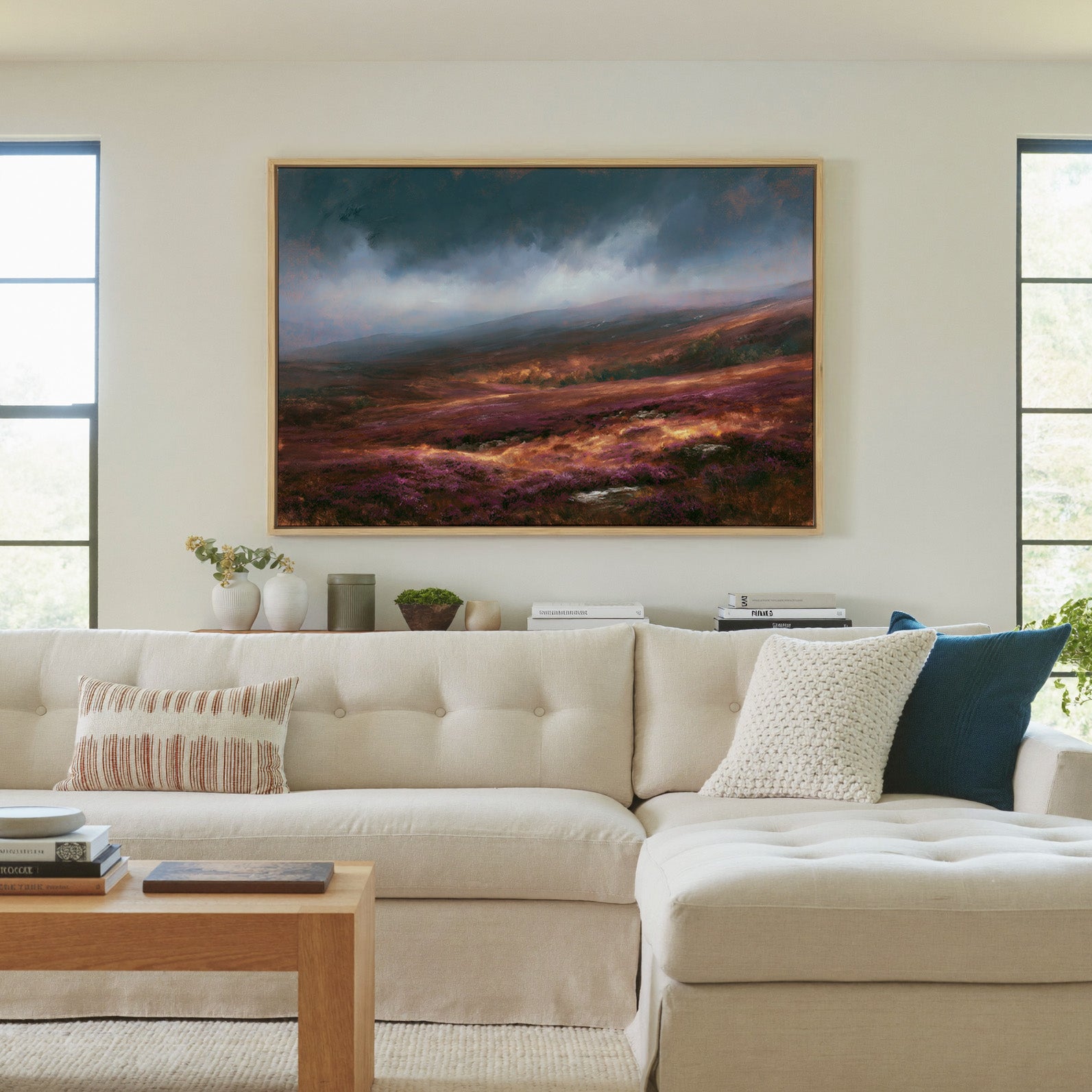 late autumn heather hills under a stormy sky canvas wall art in a natural wood frame in a living room