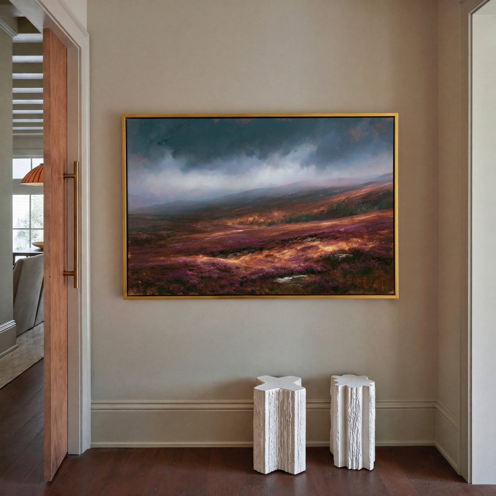 late autumn heather hills under a stormy sky canvas wall art in a gold frame in a styled room setting