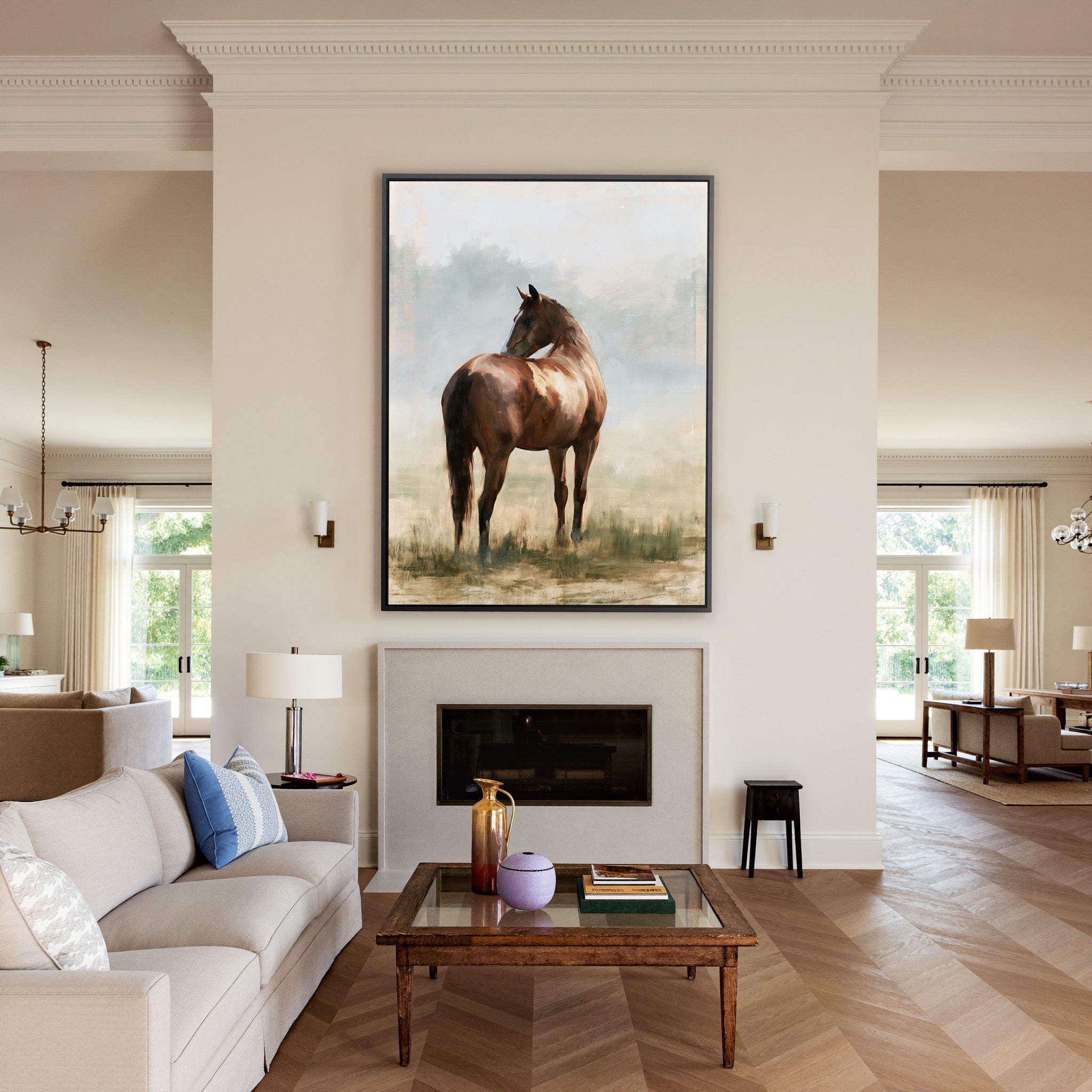 single chestnut horse in a pale open field canvas wall art in a black frame above a mantel