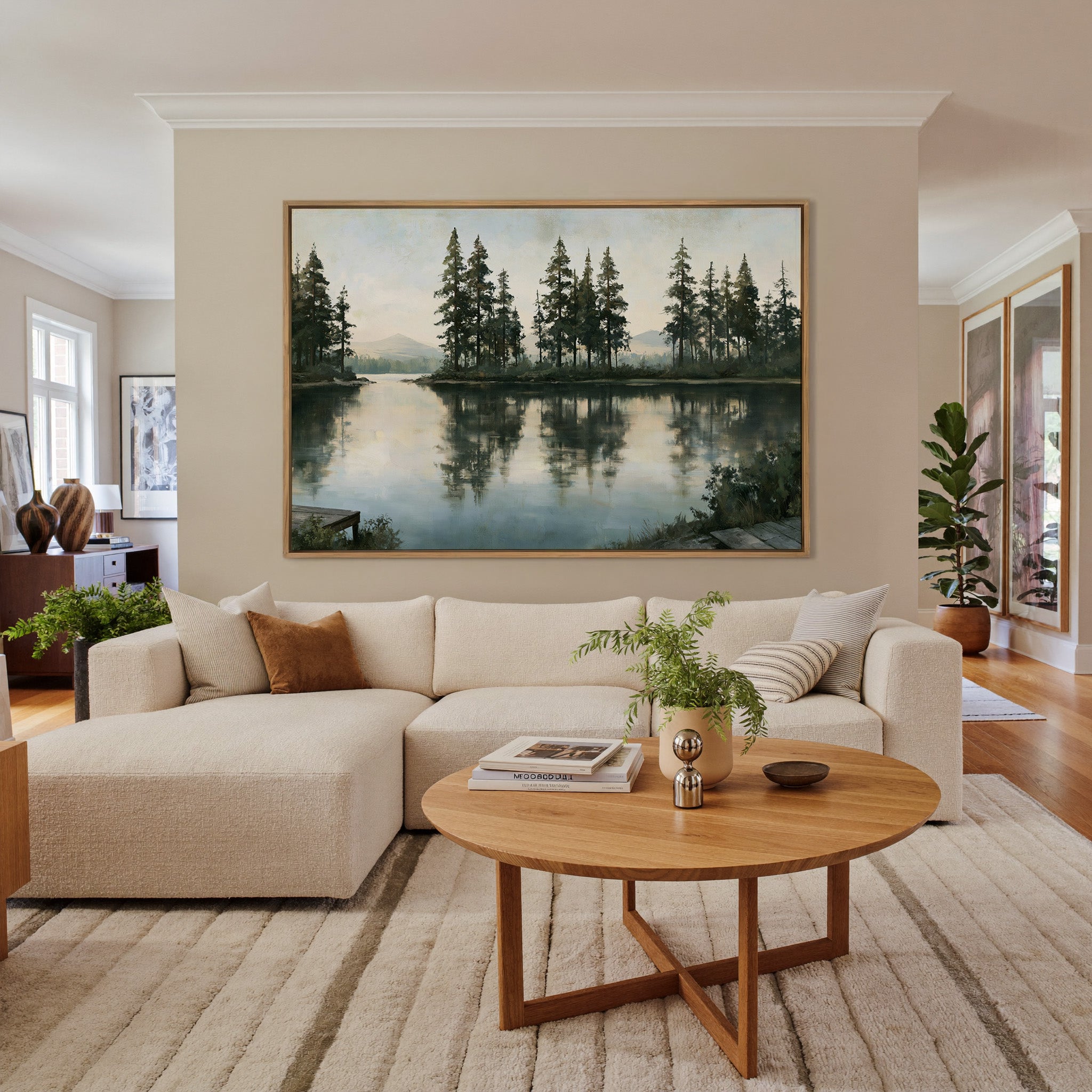 quiet lake with tall pines and pale distant canvas wall art in an oak frame in a living room