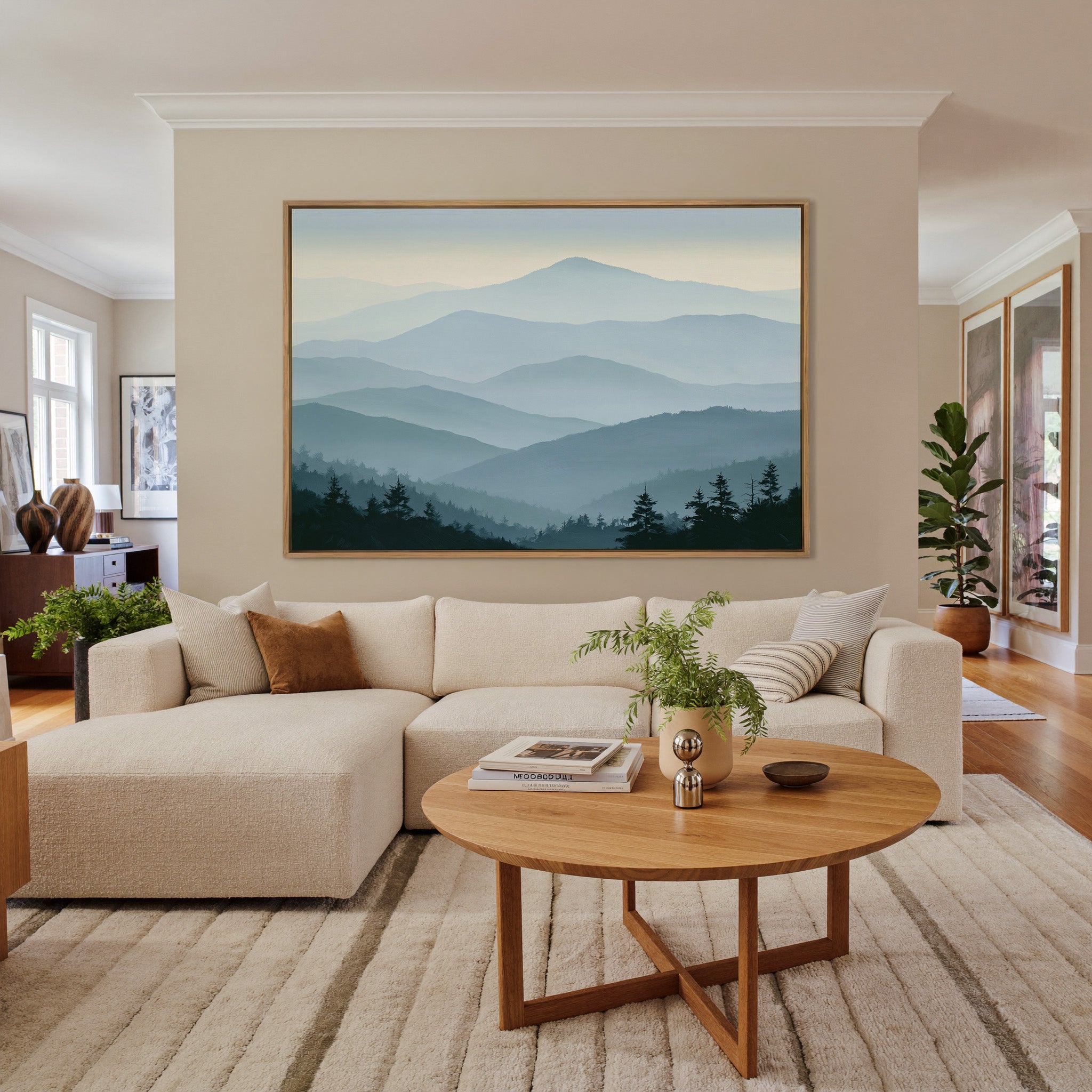 layered blue mountain ridges with mist and dark canvas wall art in an oak frame in a living room