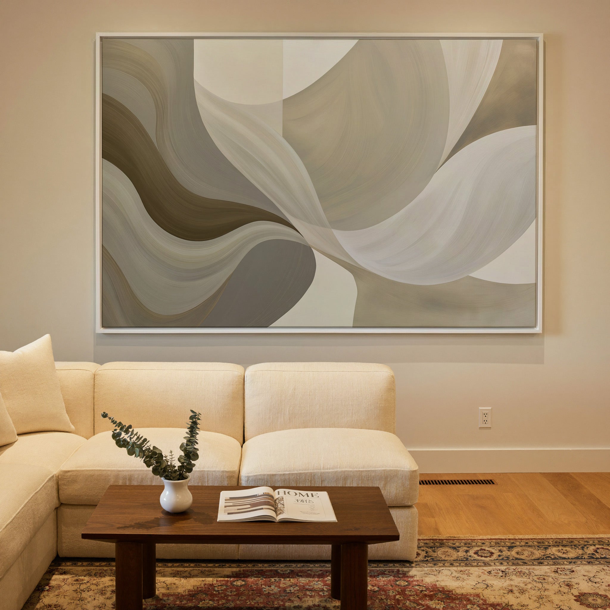 neutral abstract with large sweeping cream, canvas wall art in a white frame in a styled room setting