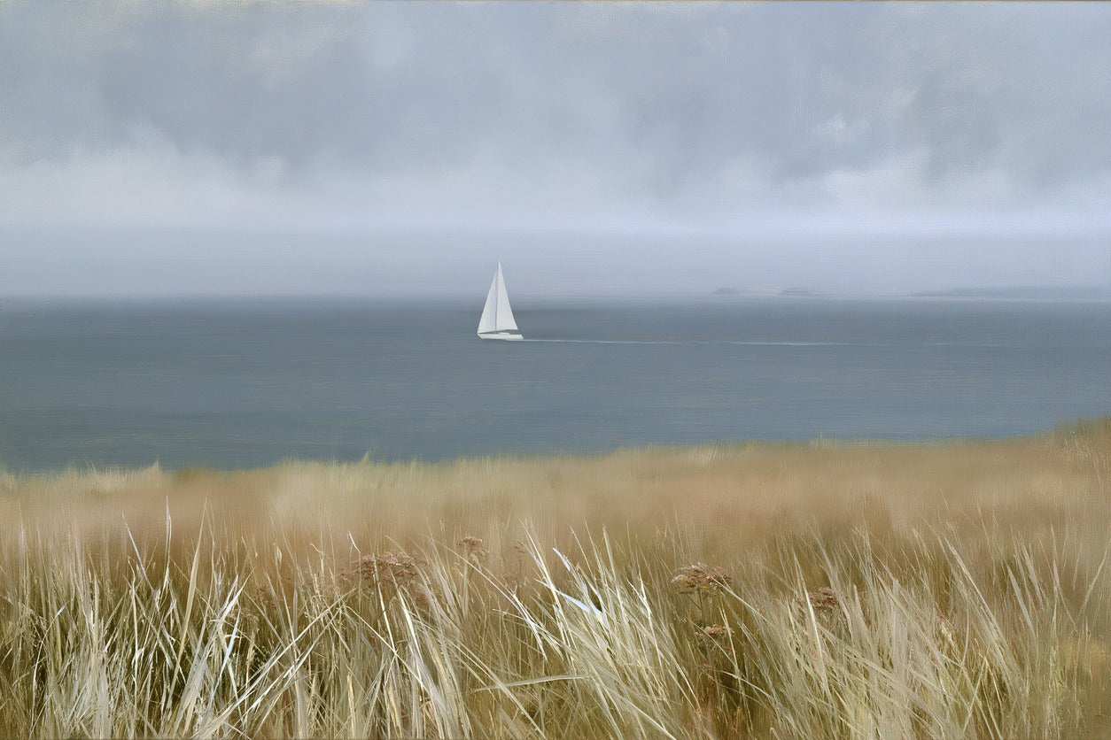 Distant white sailboat on a gray blue sea beneath a low cloudy sky with clear color and shape detail