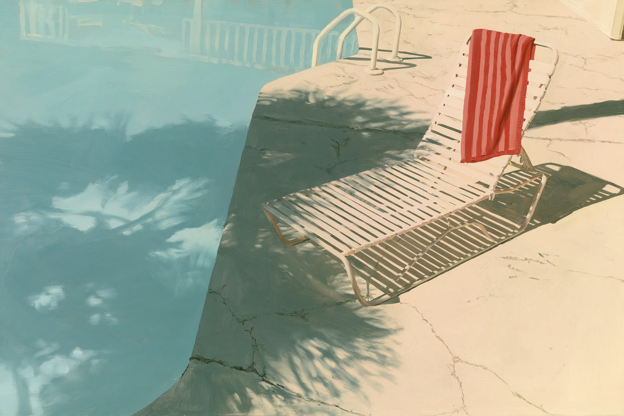 Empty motel pool with turquoise water, white lounge chair, and red striped towel in strong sun