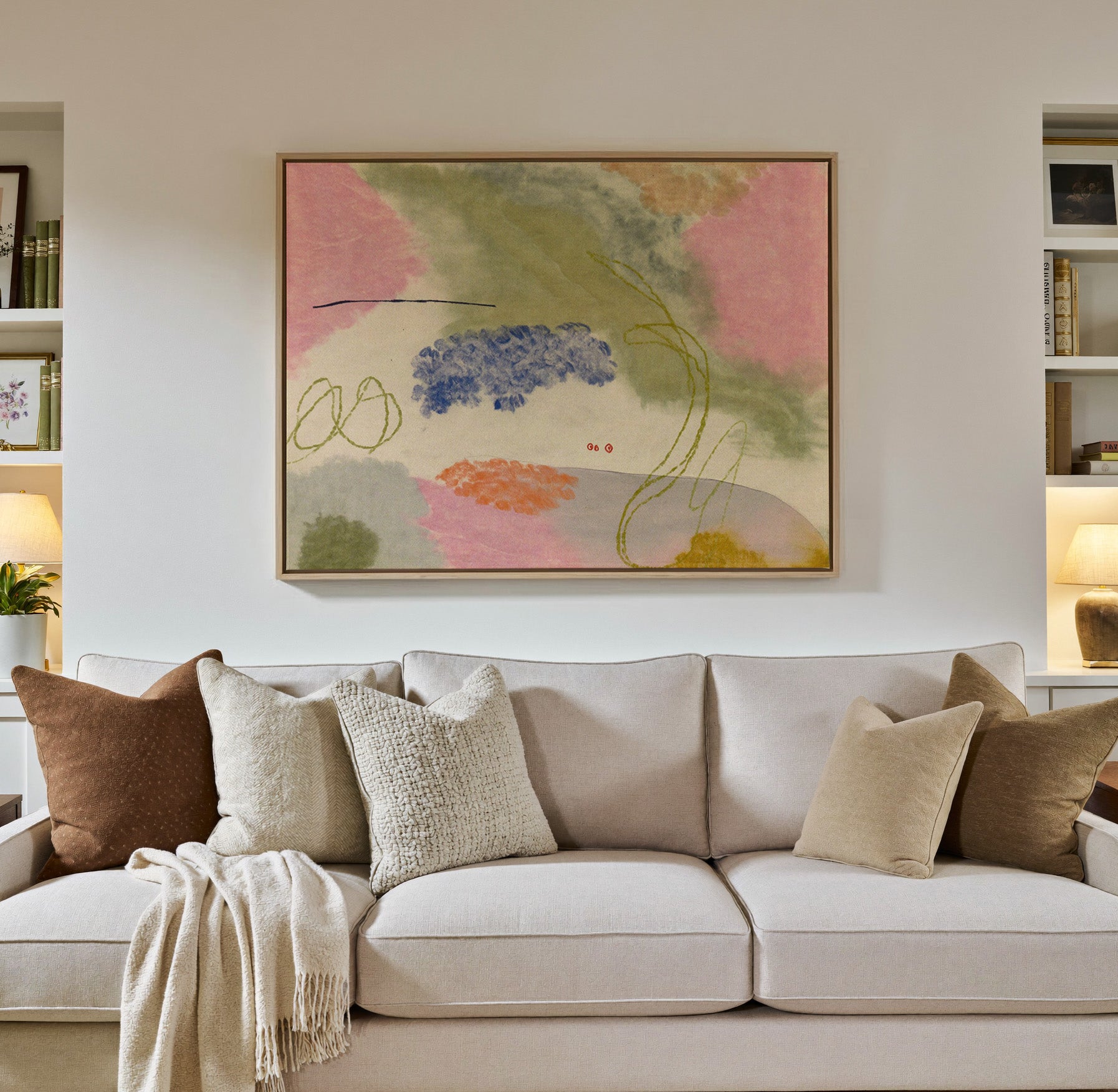 soft pink, green, blue, and orange abstract canvas wall art in a natural wood frame in a styled room setting