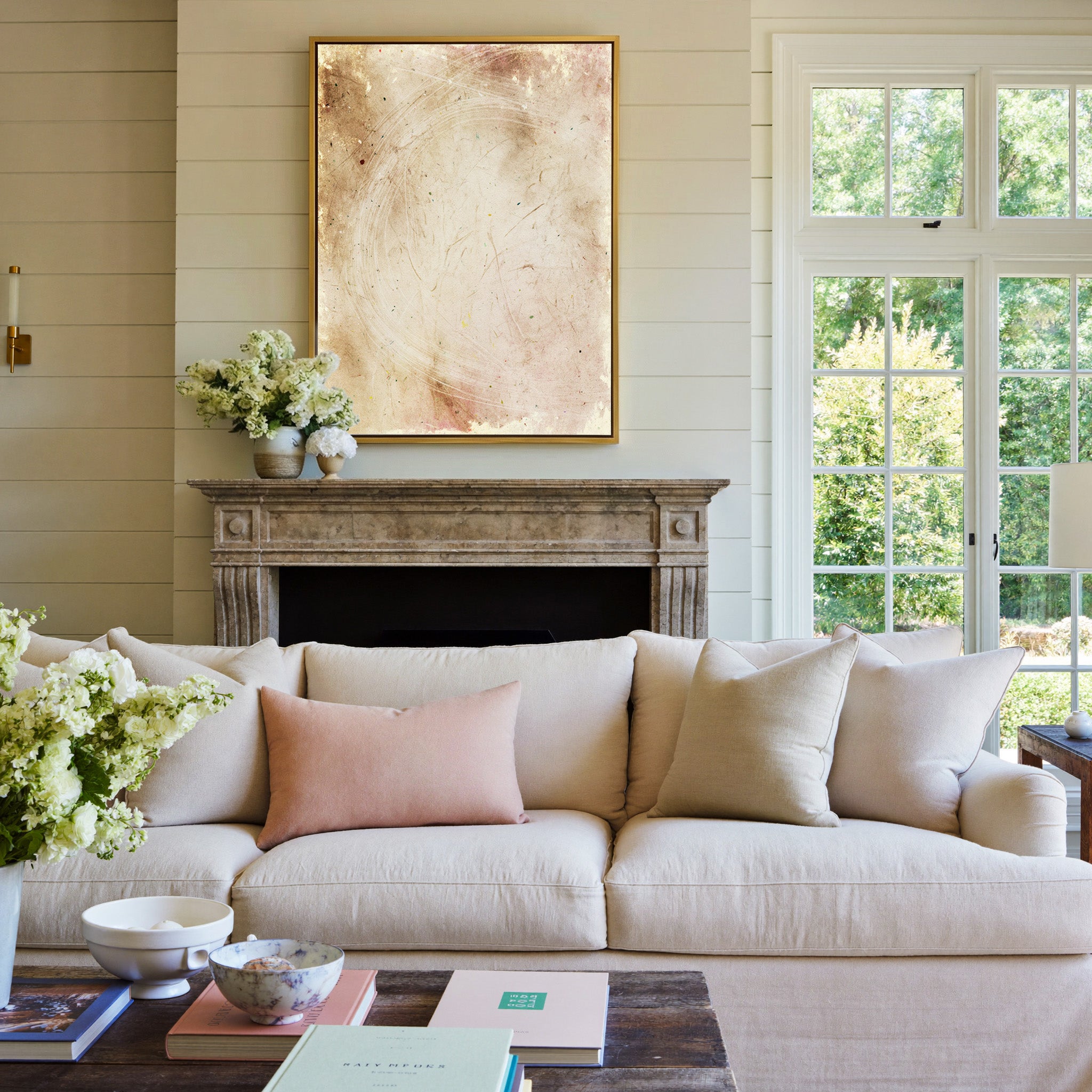 warm beige abstract with pale curved lines canvas wall art in a gold frame above a mantel