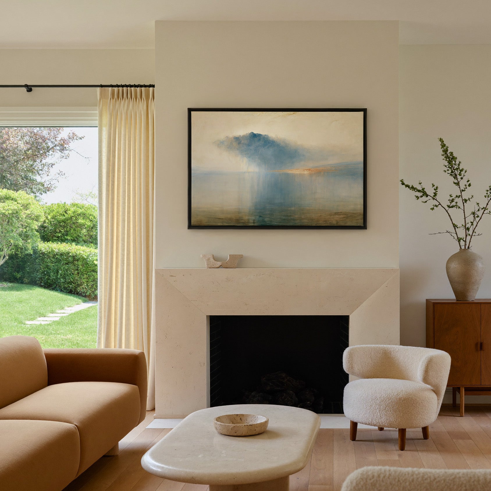 blue storm cloud over still water canvas wall art in a black frame above a mantel
