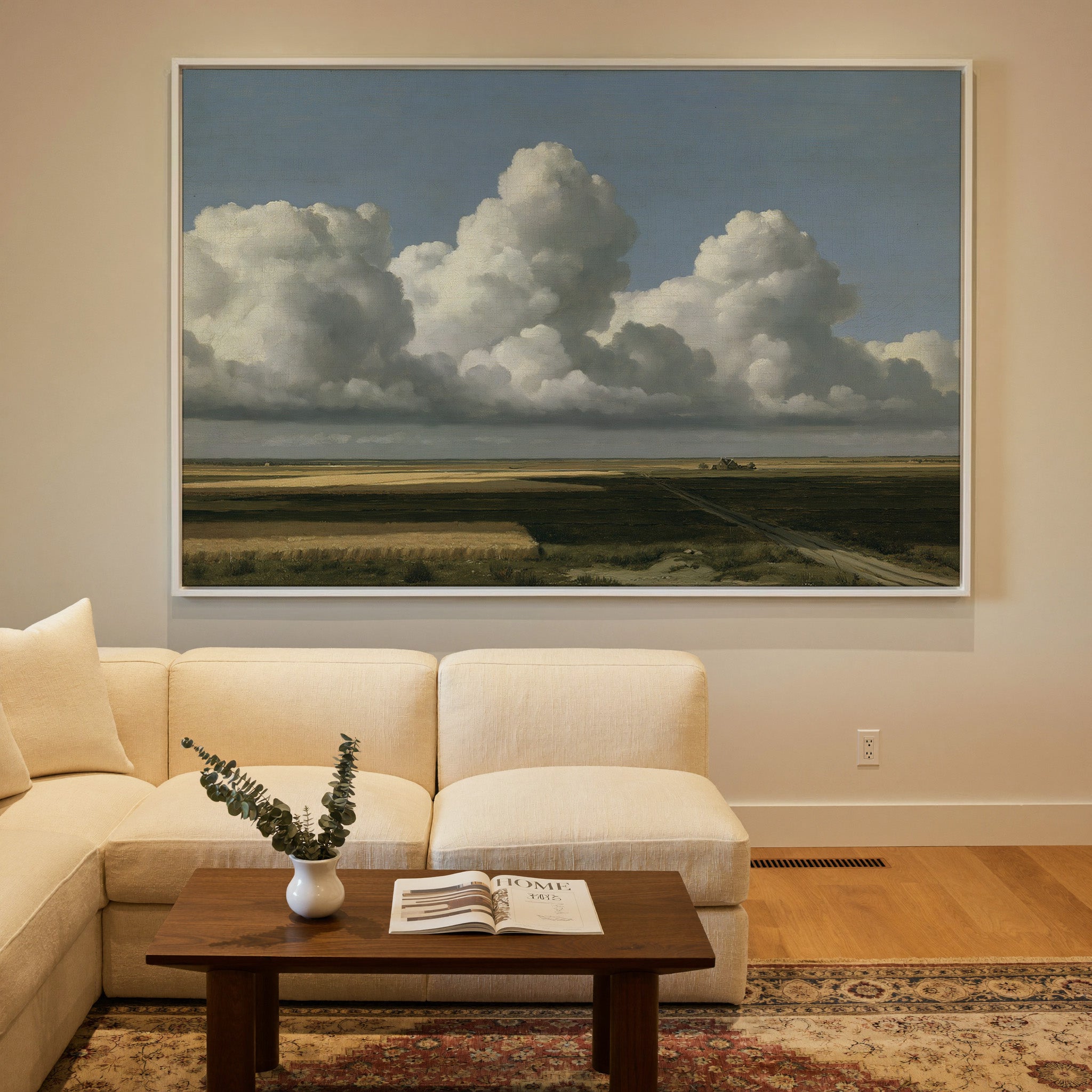 vast blue sky over low patchwork fields canvas wall art in a white frame in a styled room setting