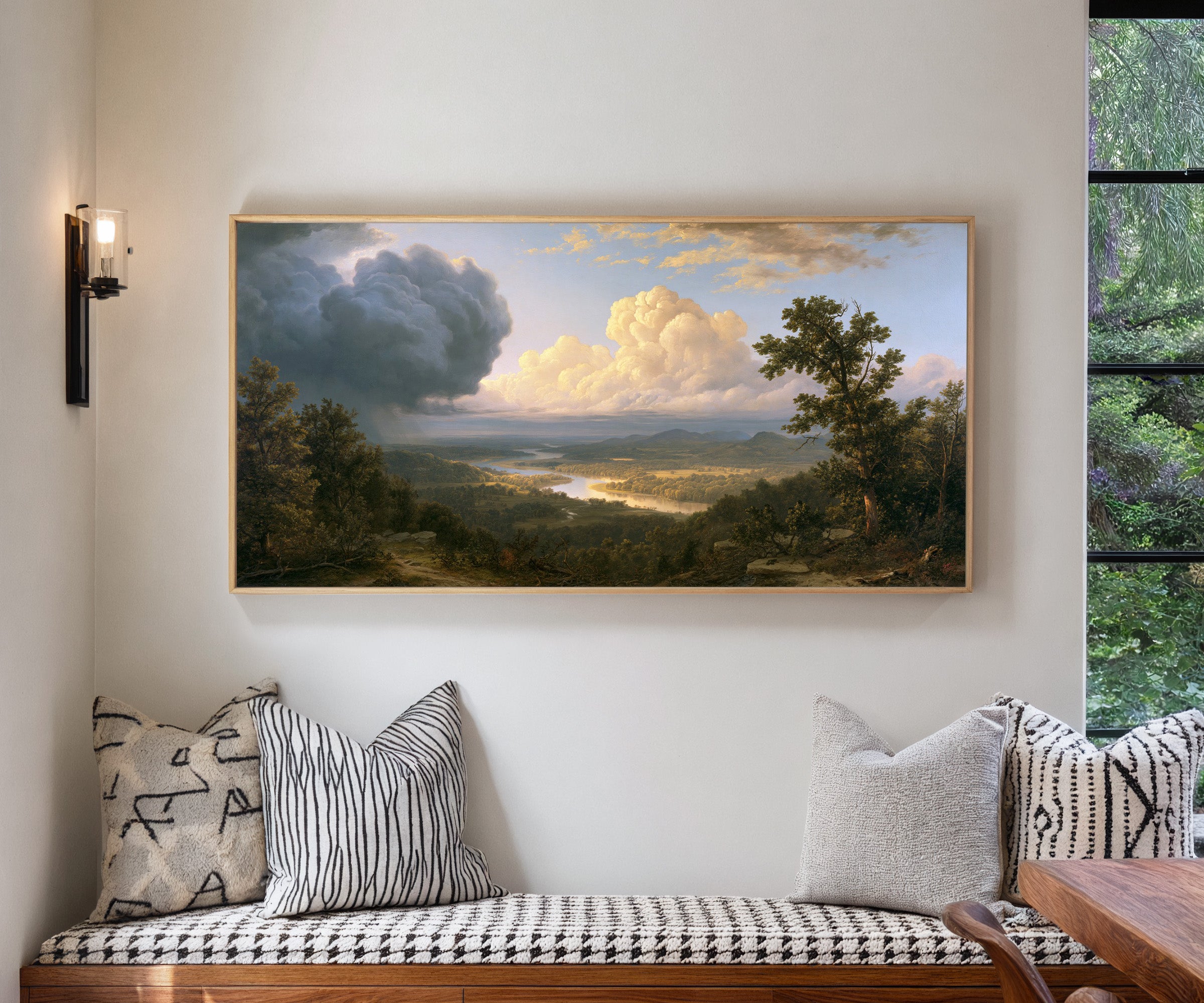 wide river valley with towering clouds canvas wall art in a natural wood frame in a living room