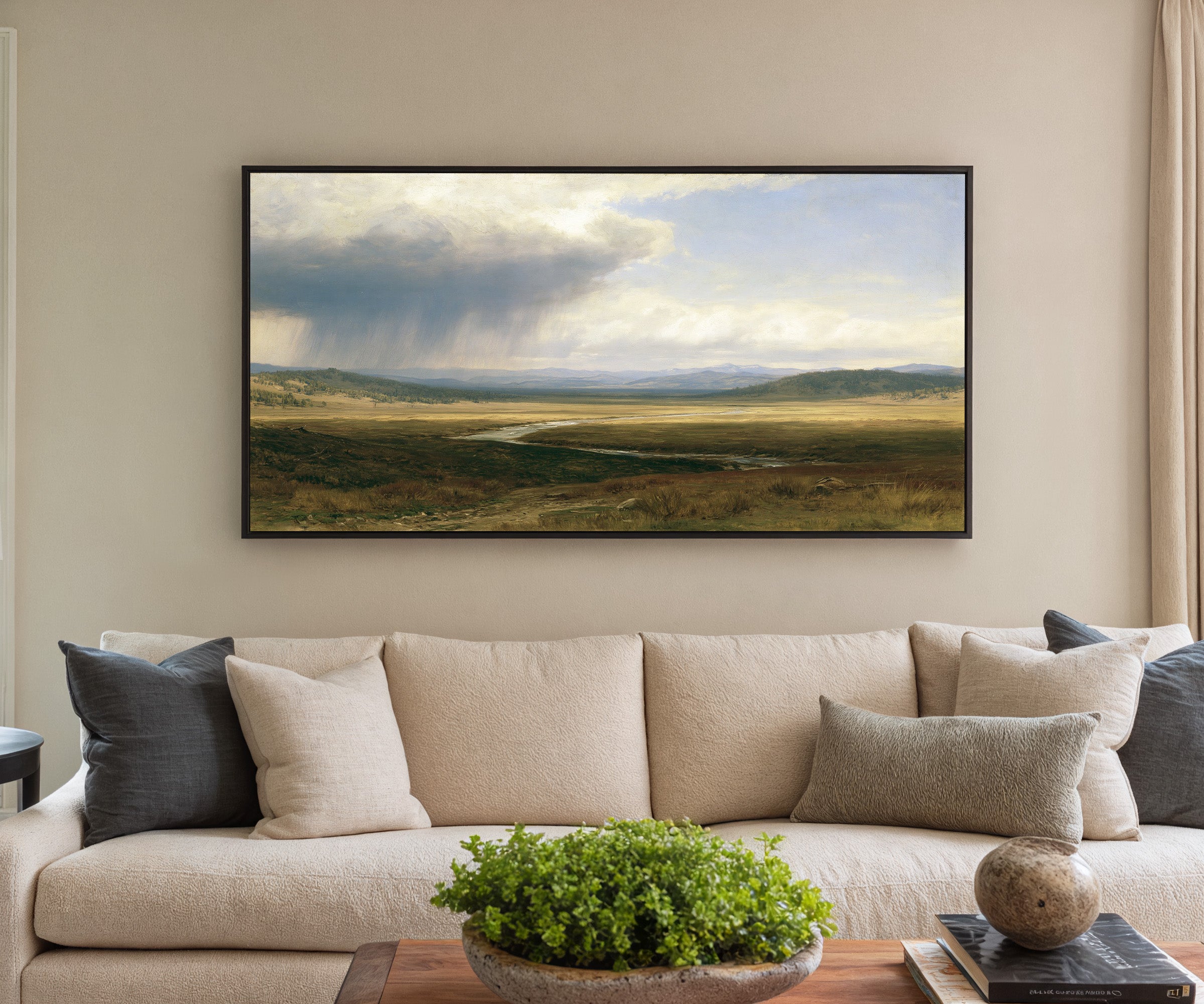 broad plain under a split storm sky canvas wall art in a black frame in a styled room setting