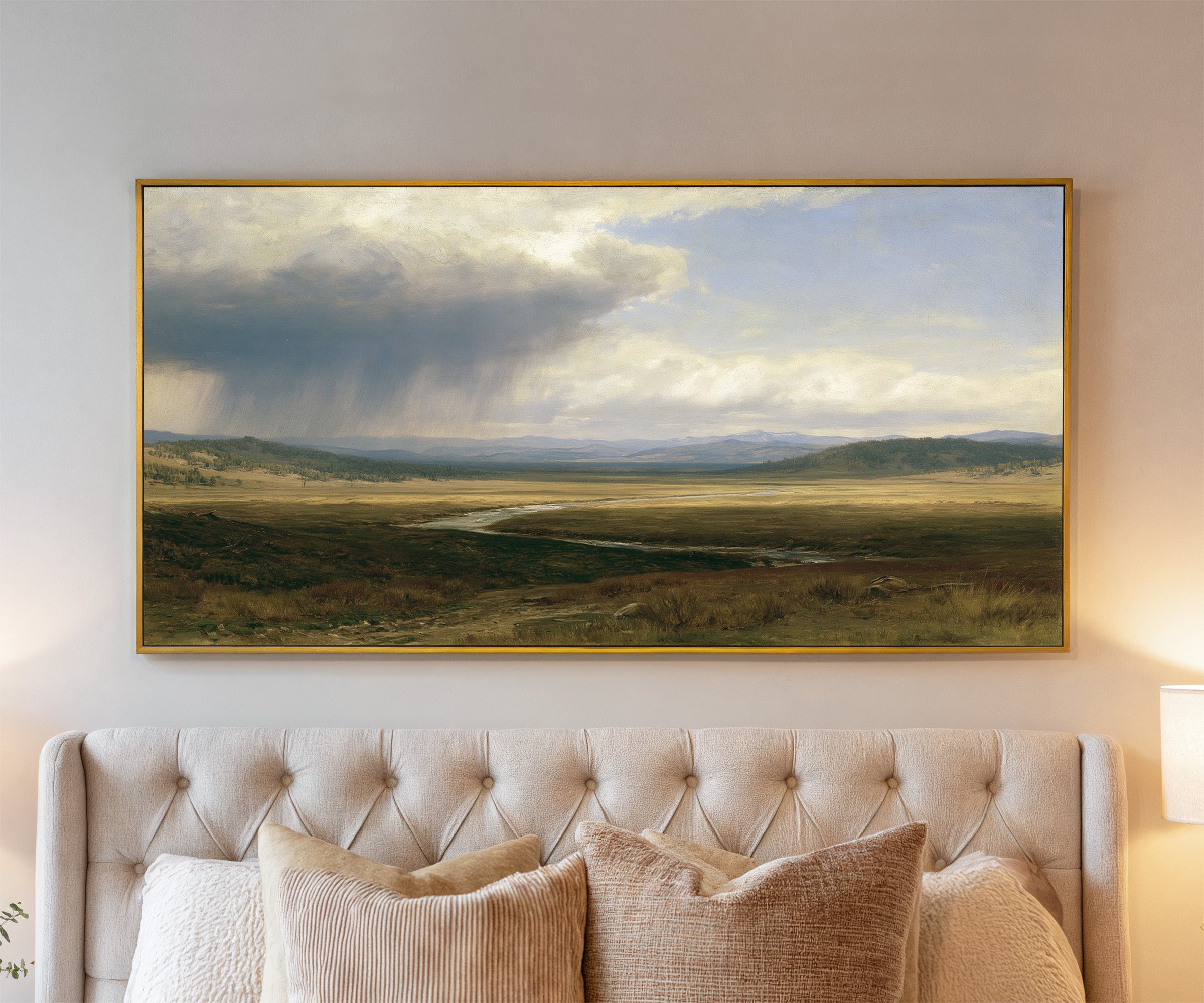 broad plain under a split storm sky canvas wall art in a gold frame above a bed