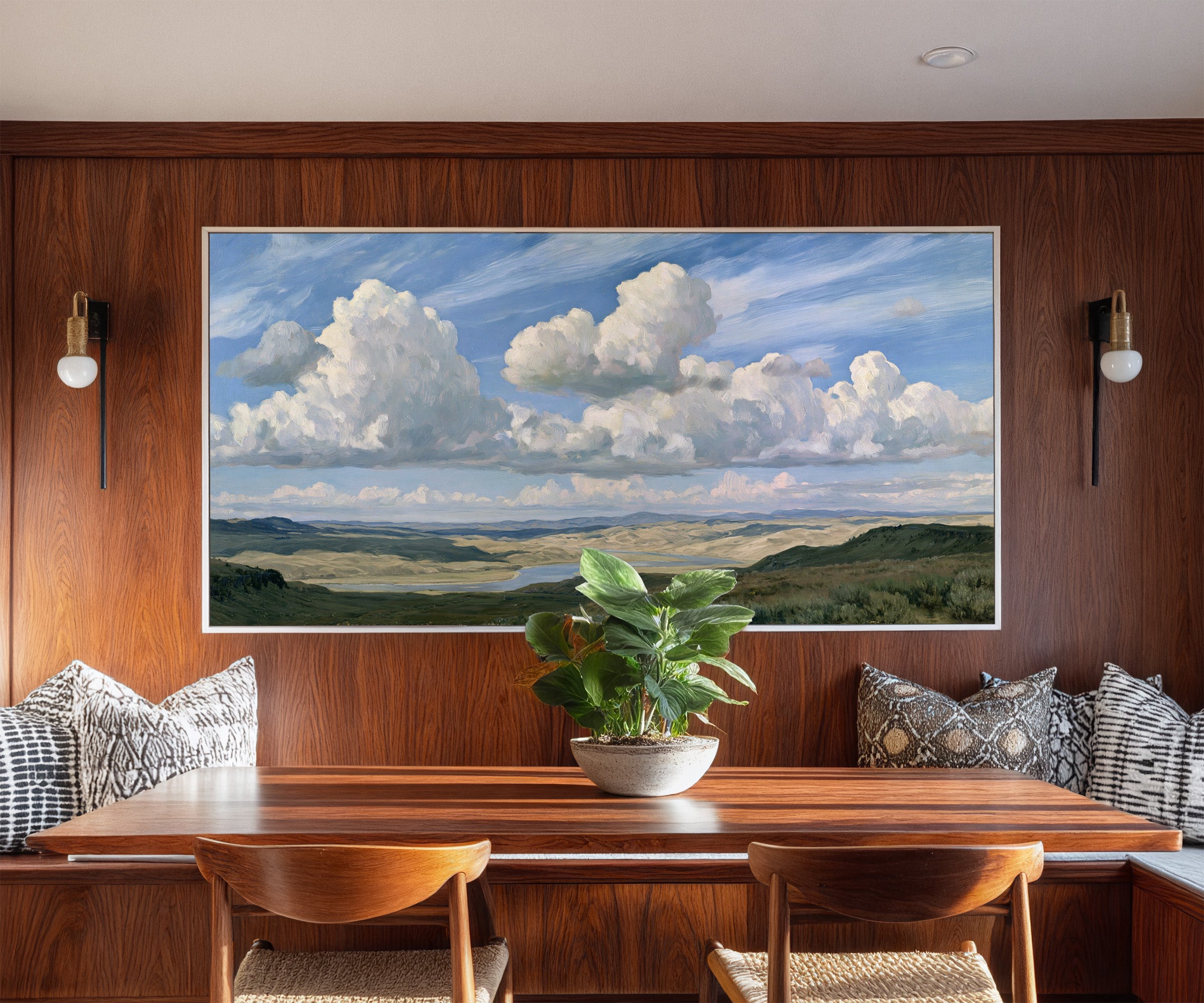 blue sky with towering white cloud banks over a canvas wall art in a white frame in a styled room setting
