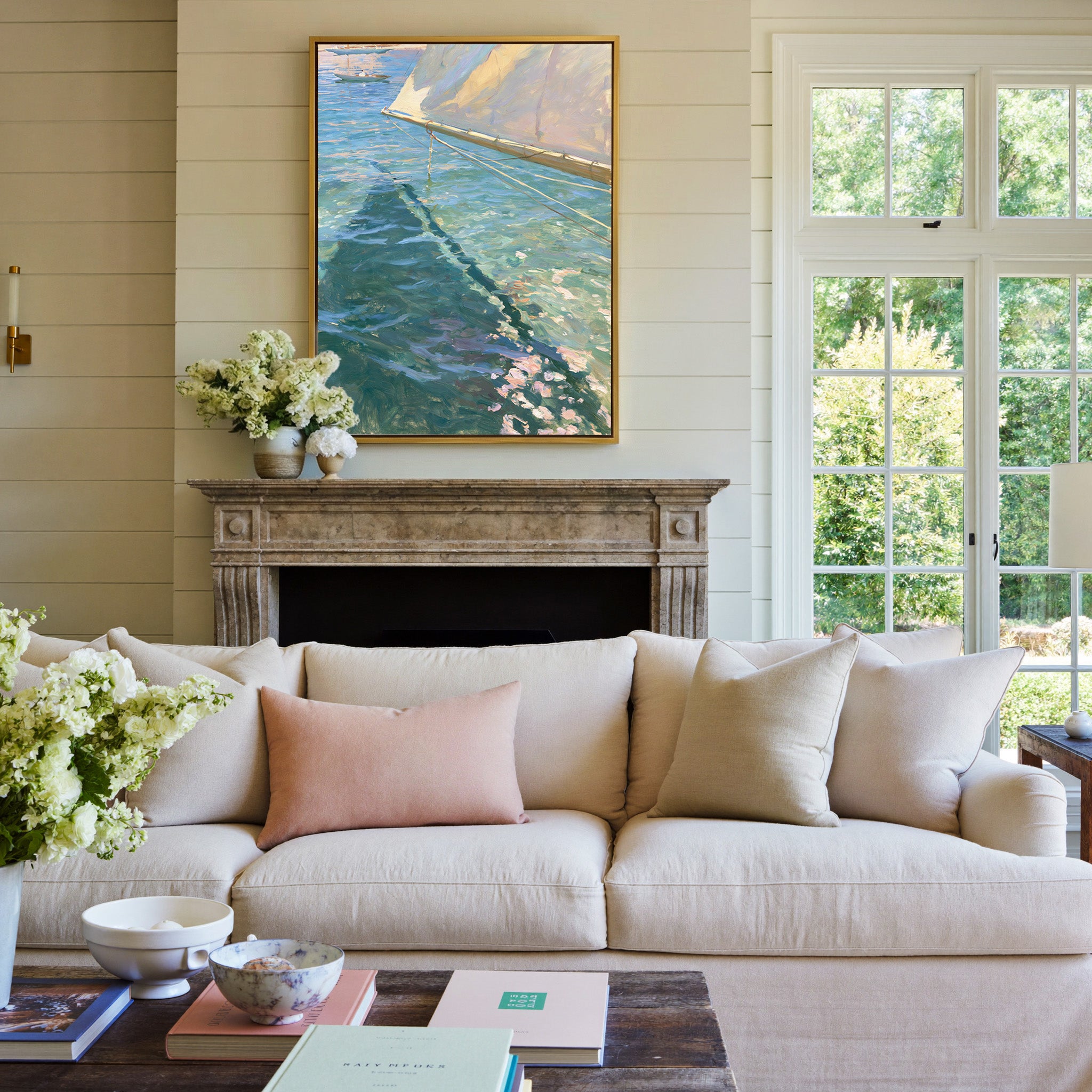cream sail and blue water canvas wall art in a gold frame above a mantel