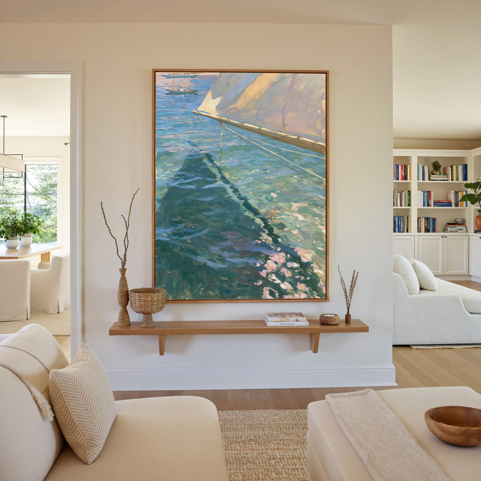 cream sail and blue water canvas wall art in an oak frame in a living room