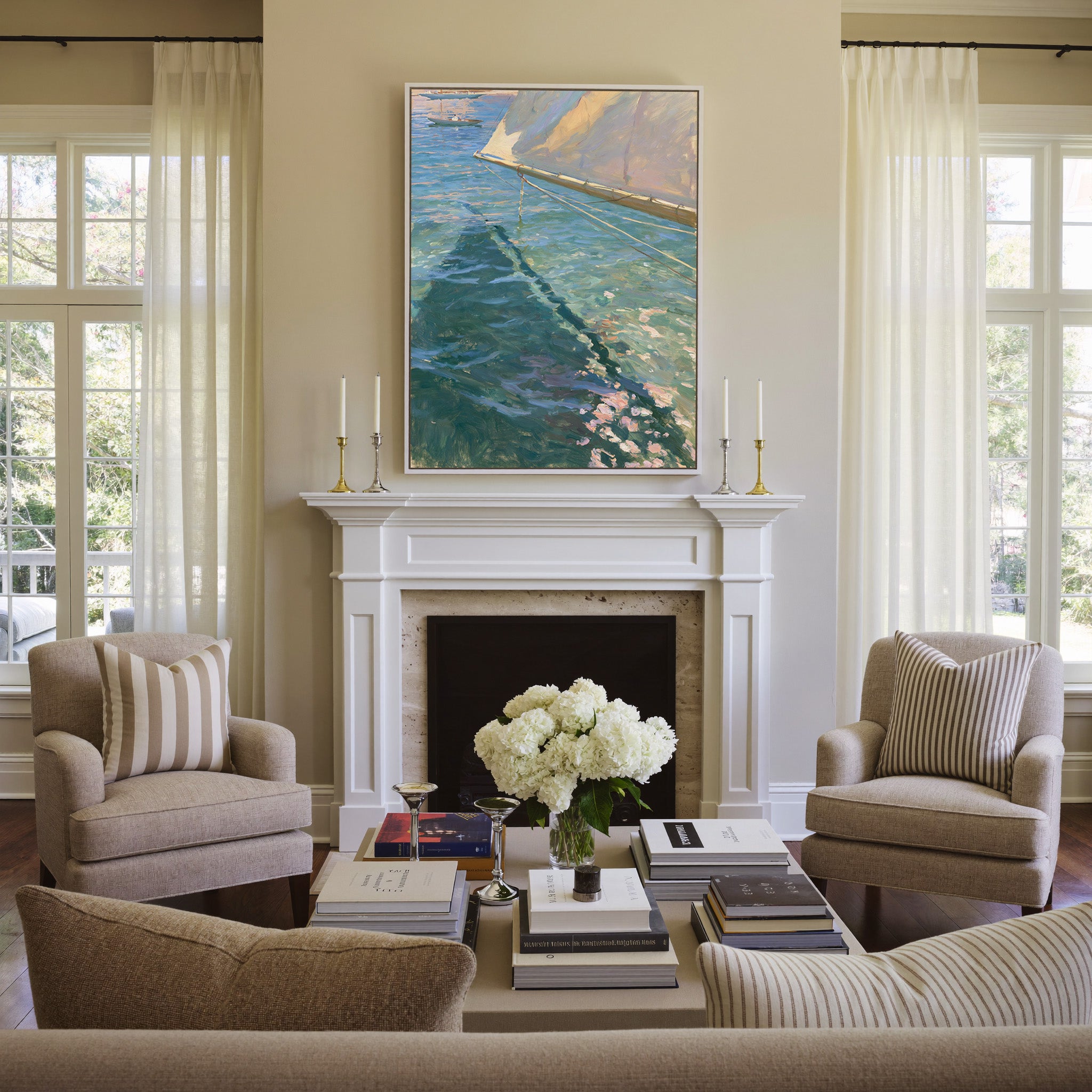 cream sail and blue water canvas wall art in a white frame above a mantel