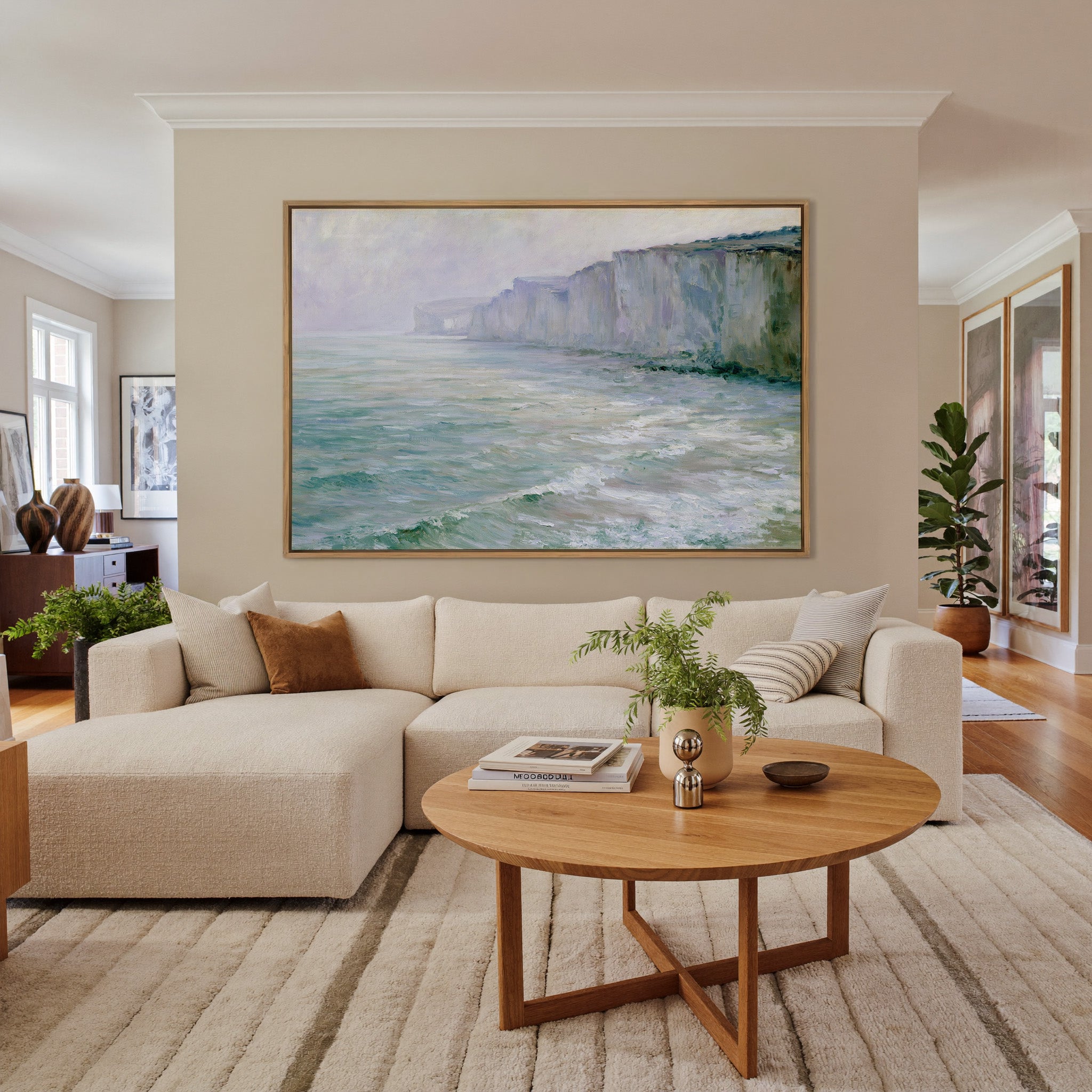 soft chalk cliffs above pale green sea canvas wall art in an oak frame in a living room