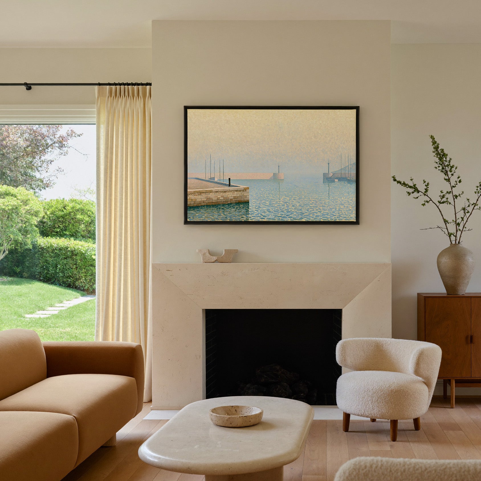 pale geometric harbor with stone pier and soft canvas wall art in a black frame above a mantel
