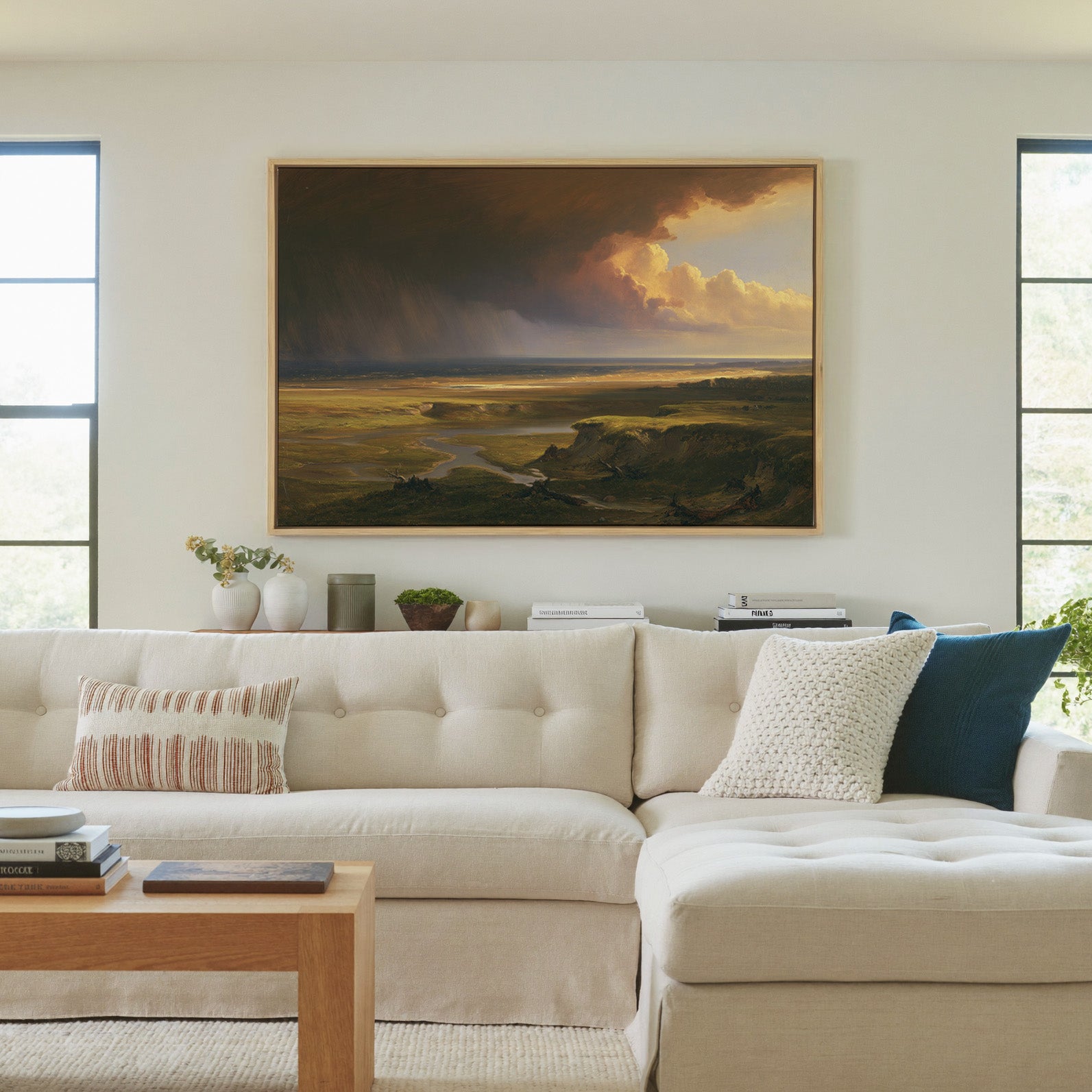 storm light over a broad coastal plain canvas wall art in a natural wood frame in a living room