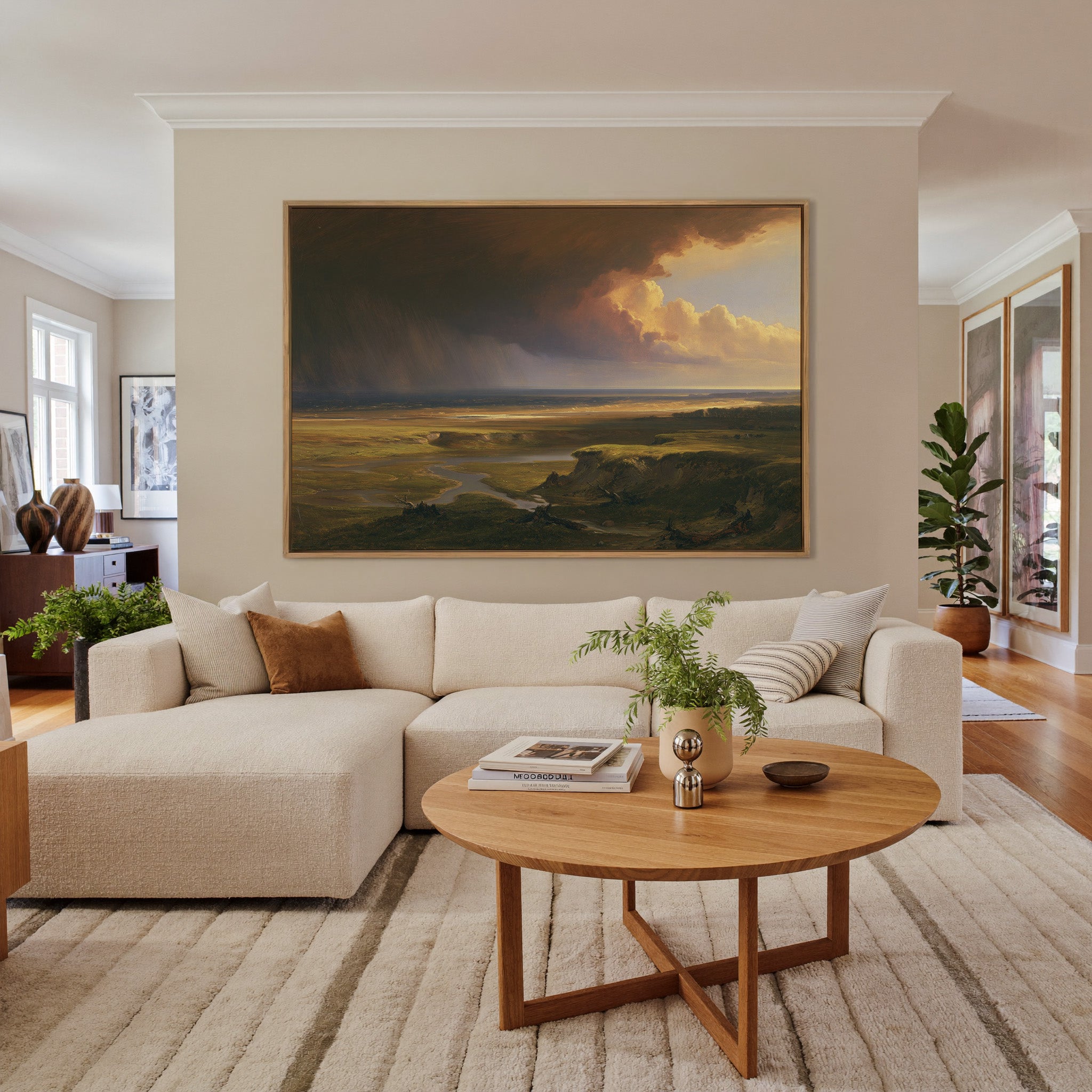 storm light over a broad coastal plain canvas wall art in an oak frame in a living room