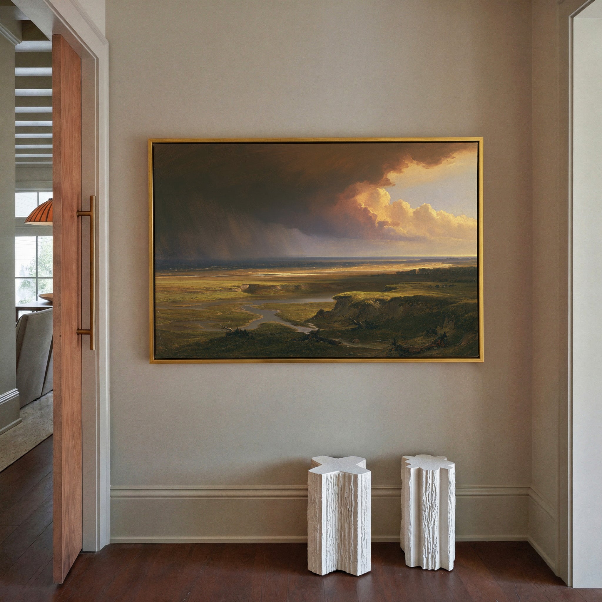 storm light over a broad coastal plain canvas wall art in a gold frame in a styled room setting