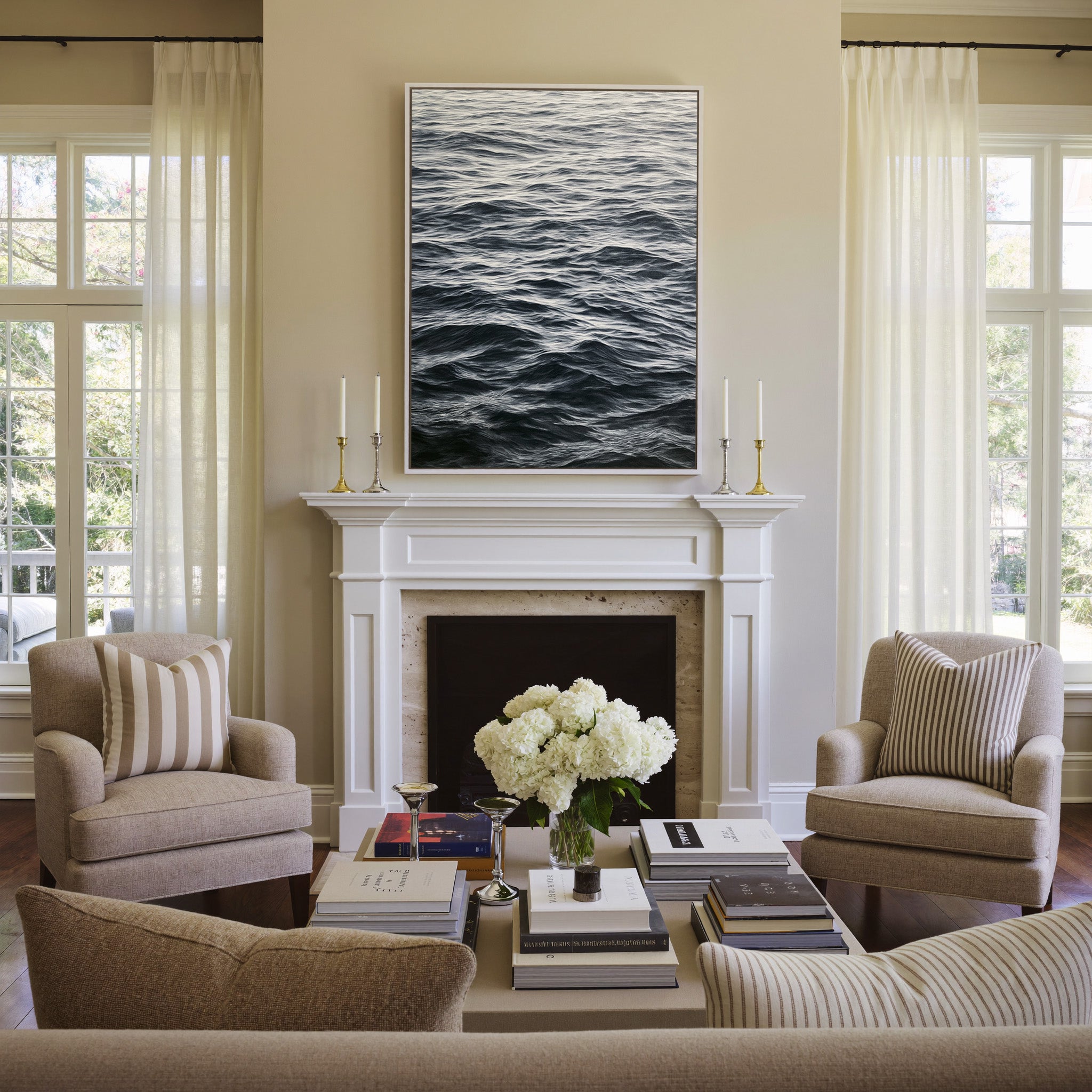 dark rippling ocean water canvas wall art in a white frame above a mantel