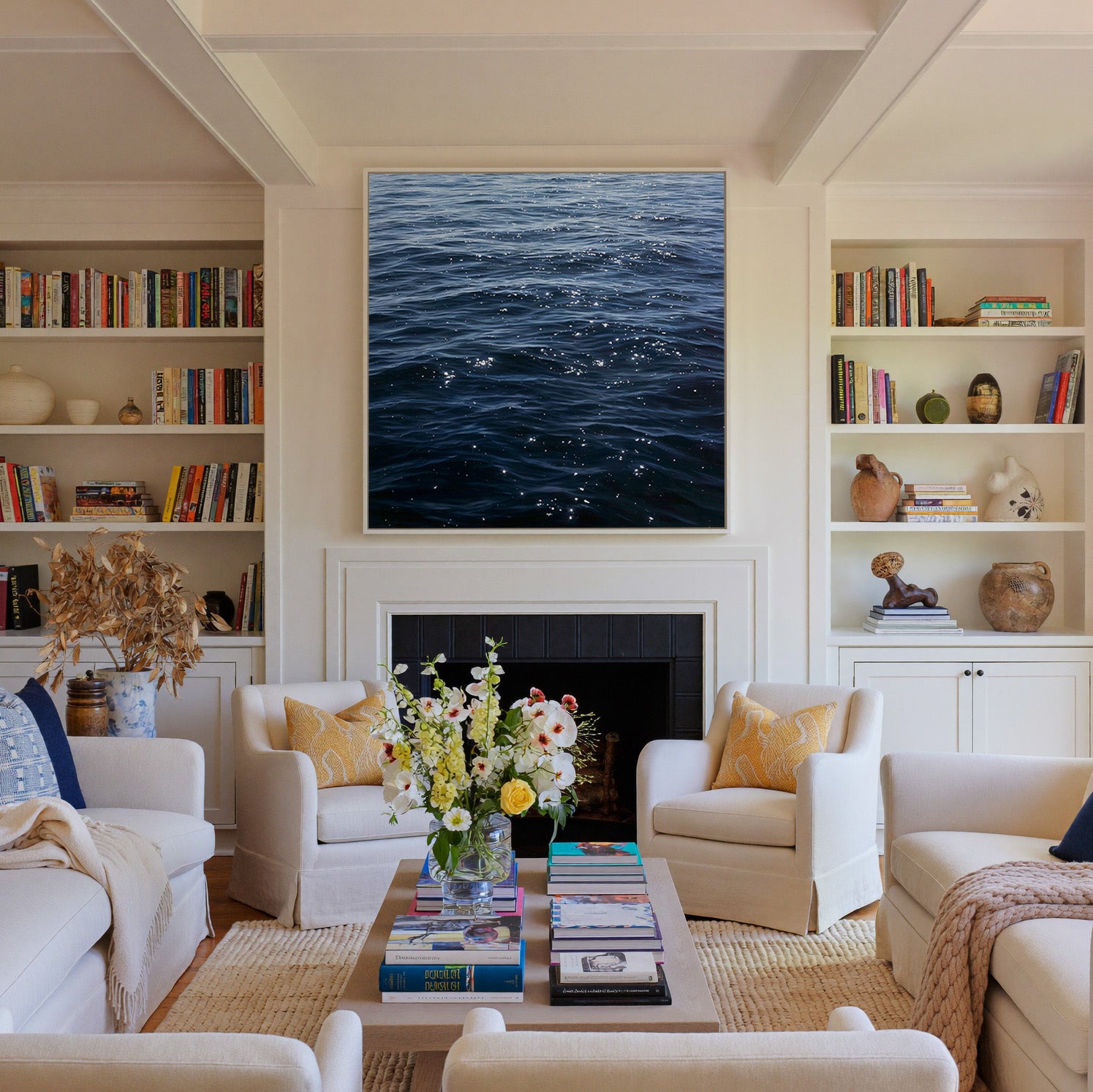 dark blue water with scattered white reflections canvas wall art in a white frame above a fireplace