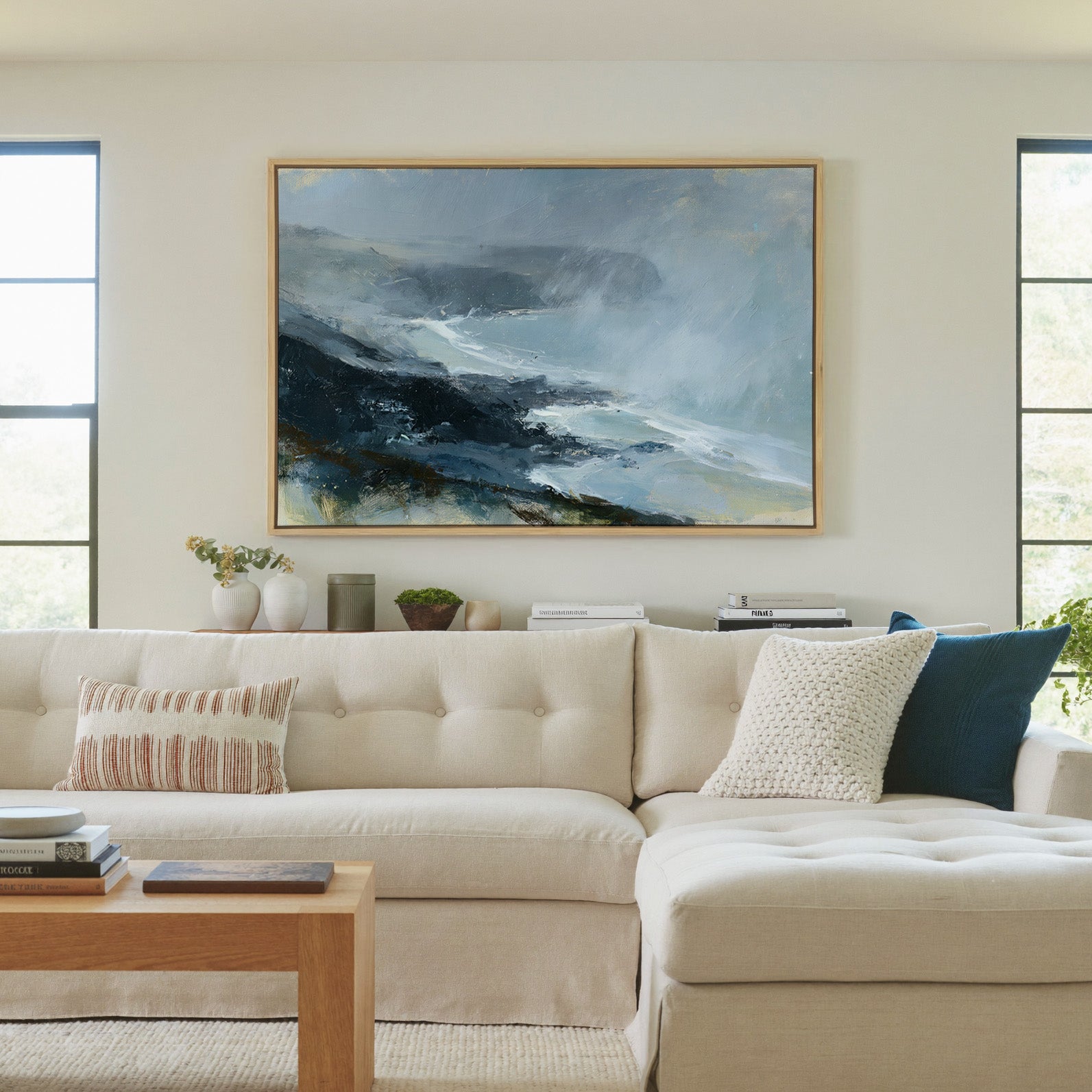 windswept coastal headland in rain and mist canvas wall art in a natural wood frame in a living room