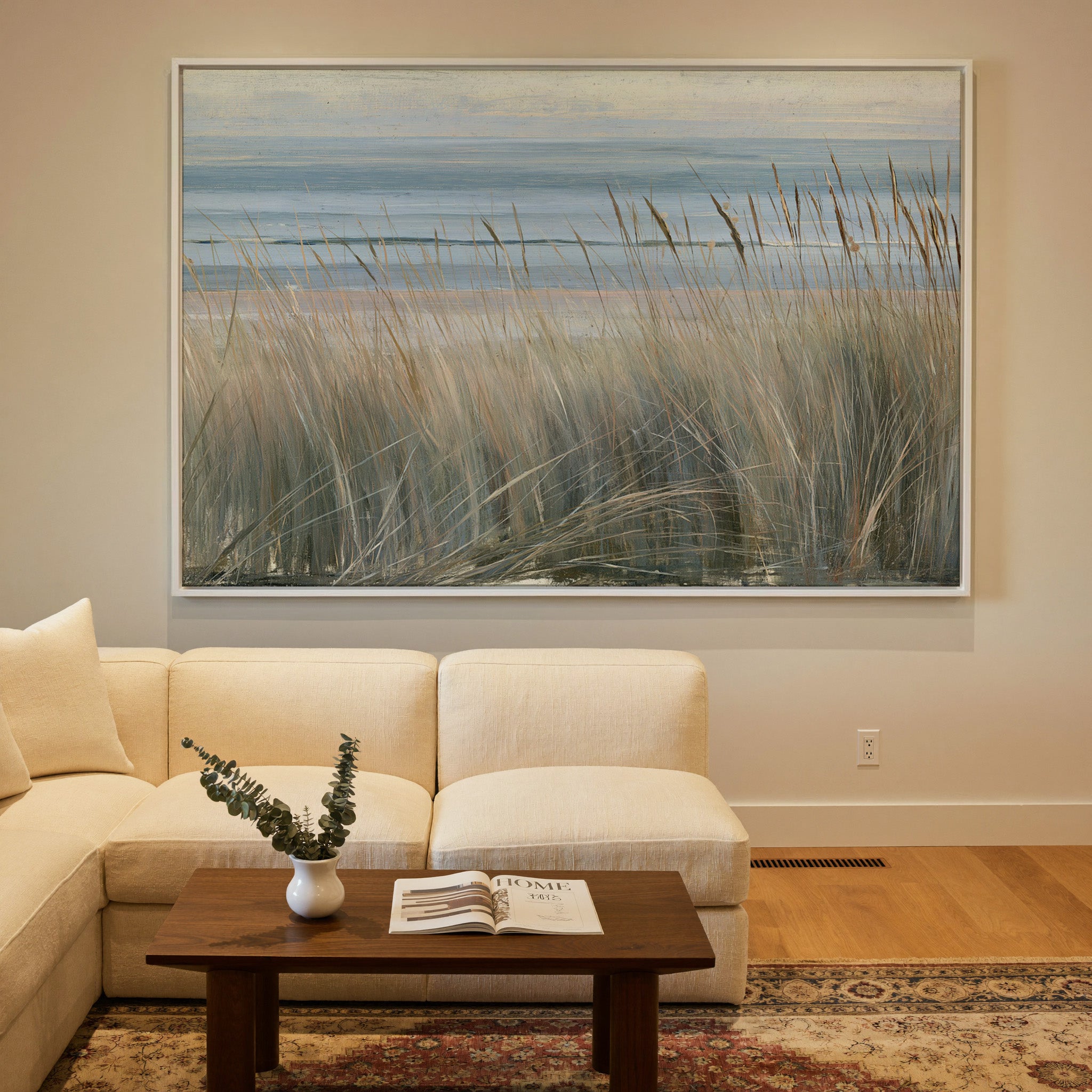 beach grass with blue water and pale dune bands canvas wall art in a white frame in a styled room setting
