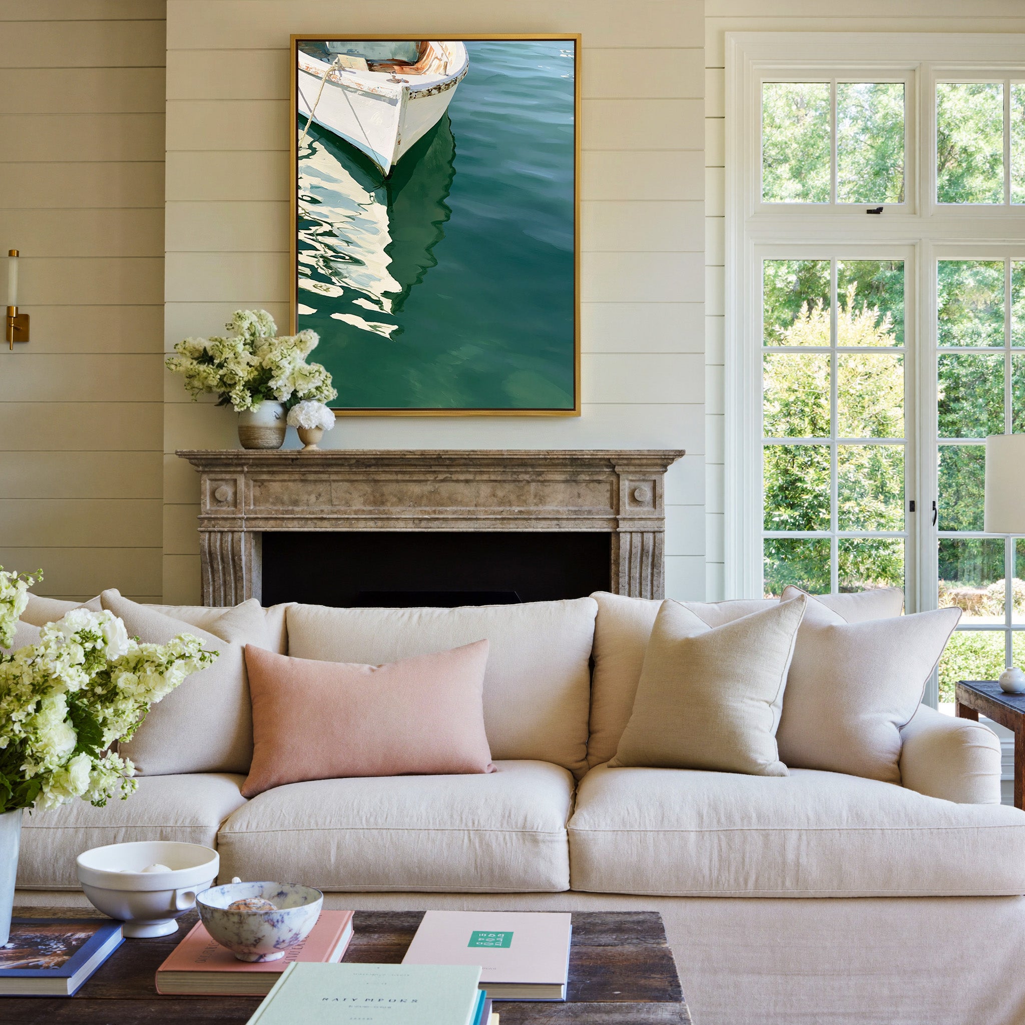 cropped white bow over deep green water canvas wall art in a gold frame above a mantel