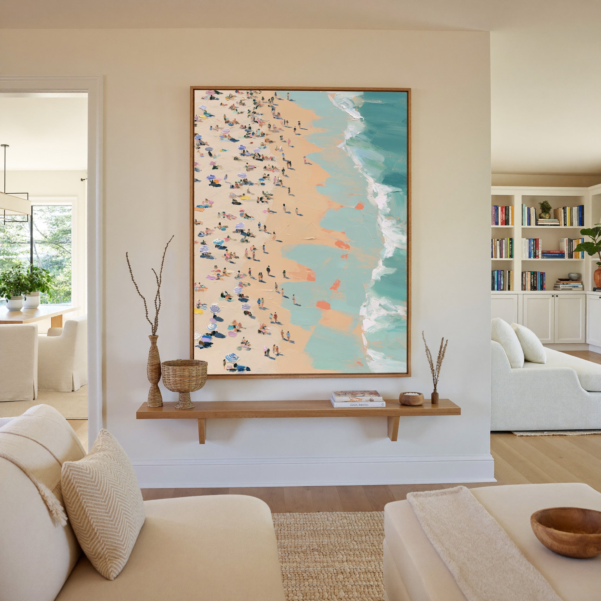 sunlit beach with turquoise surf and scattered canvas wall art in an oak frame in a living room