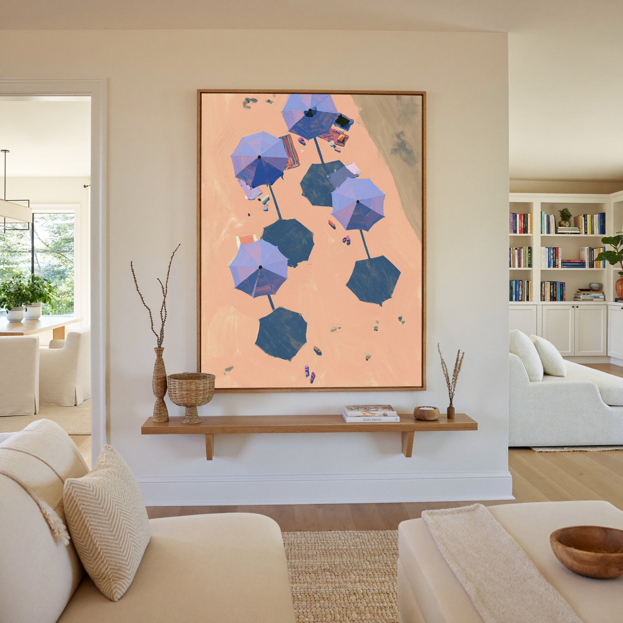 overhead beach umbrellas on peach sand canvas wall art in an oak frame in a living room