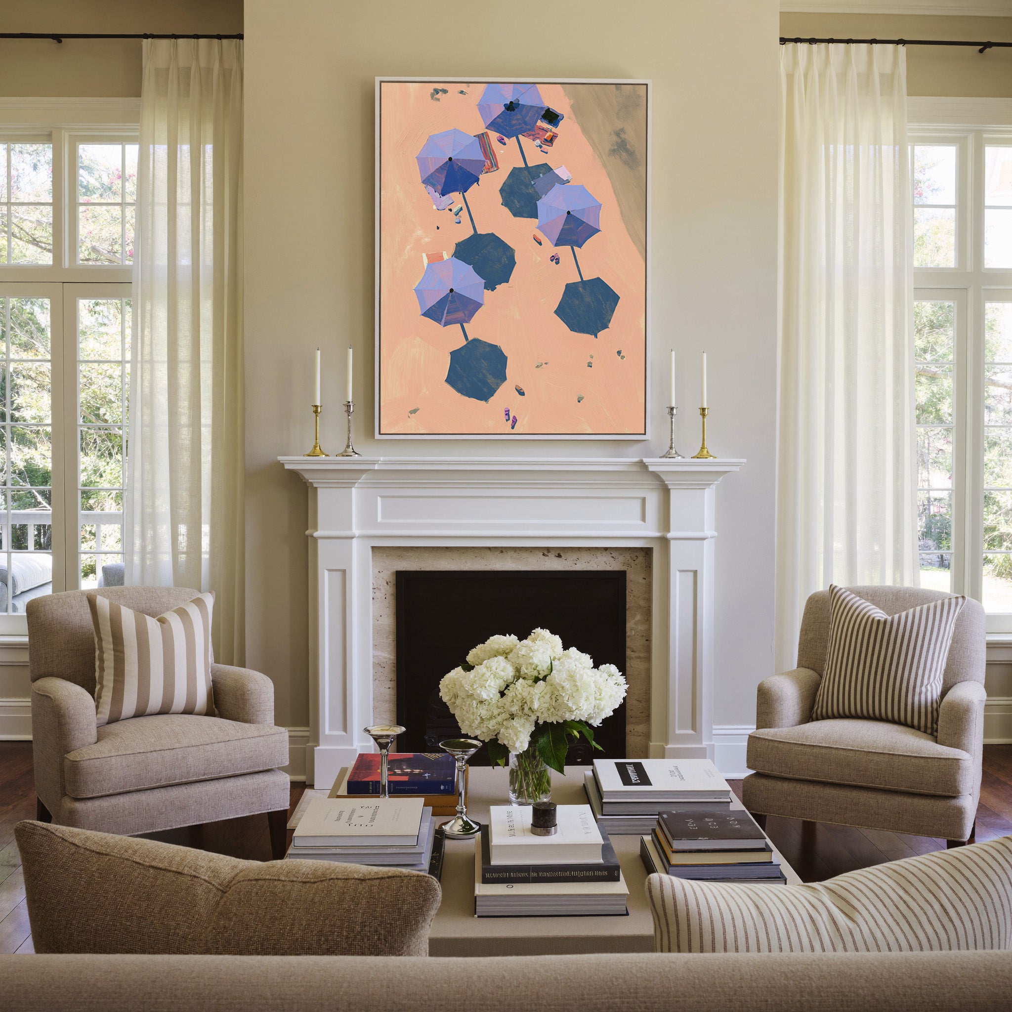 overhead beach umbrellas on peach sand canvas wall art in a white frame above a mantel