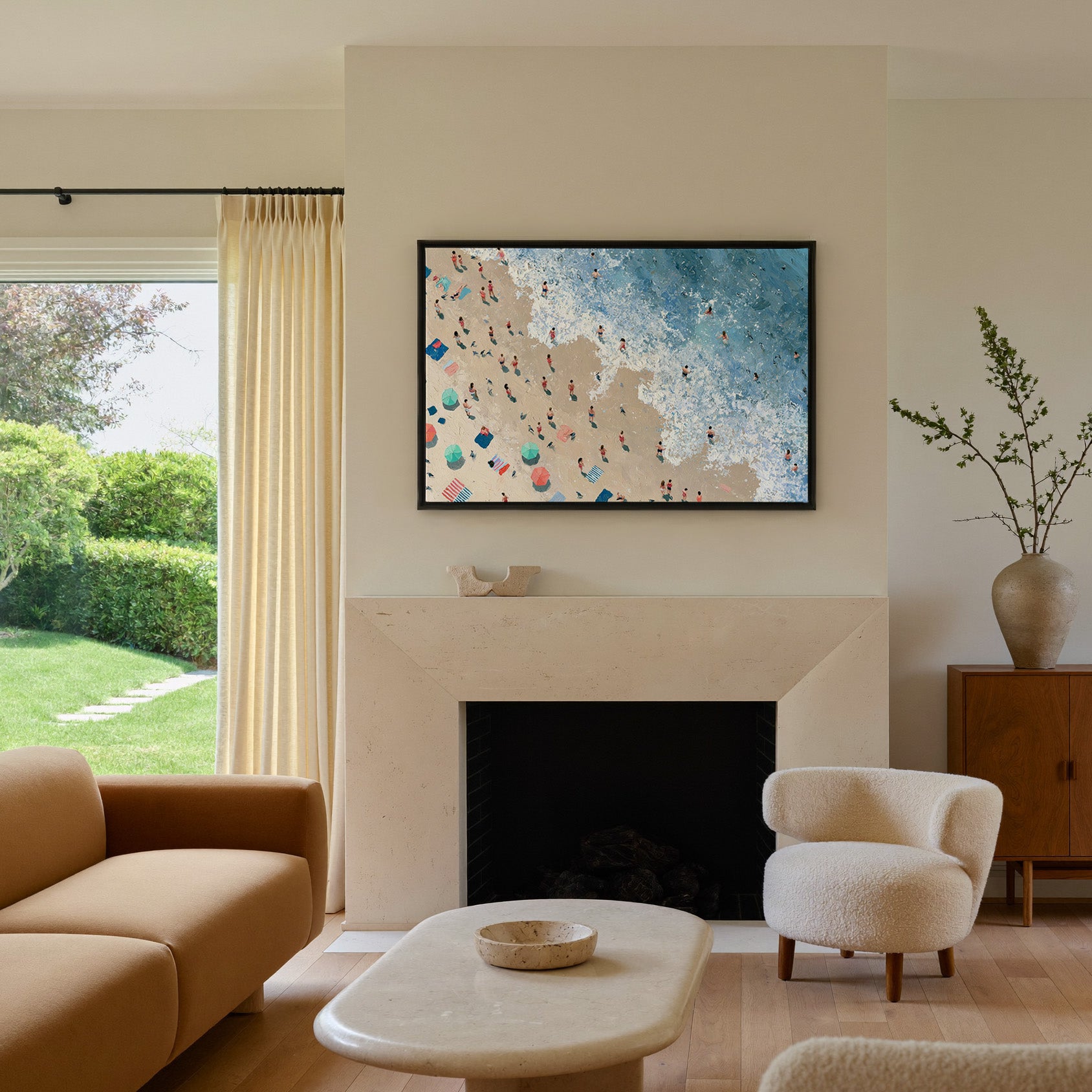 diagonal shoreline with swimmers and umbrellas canvas wall art in a black frame above a mantel