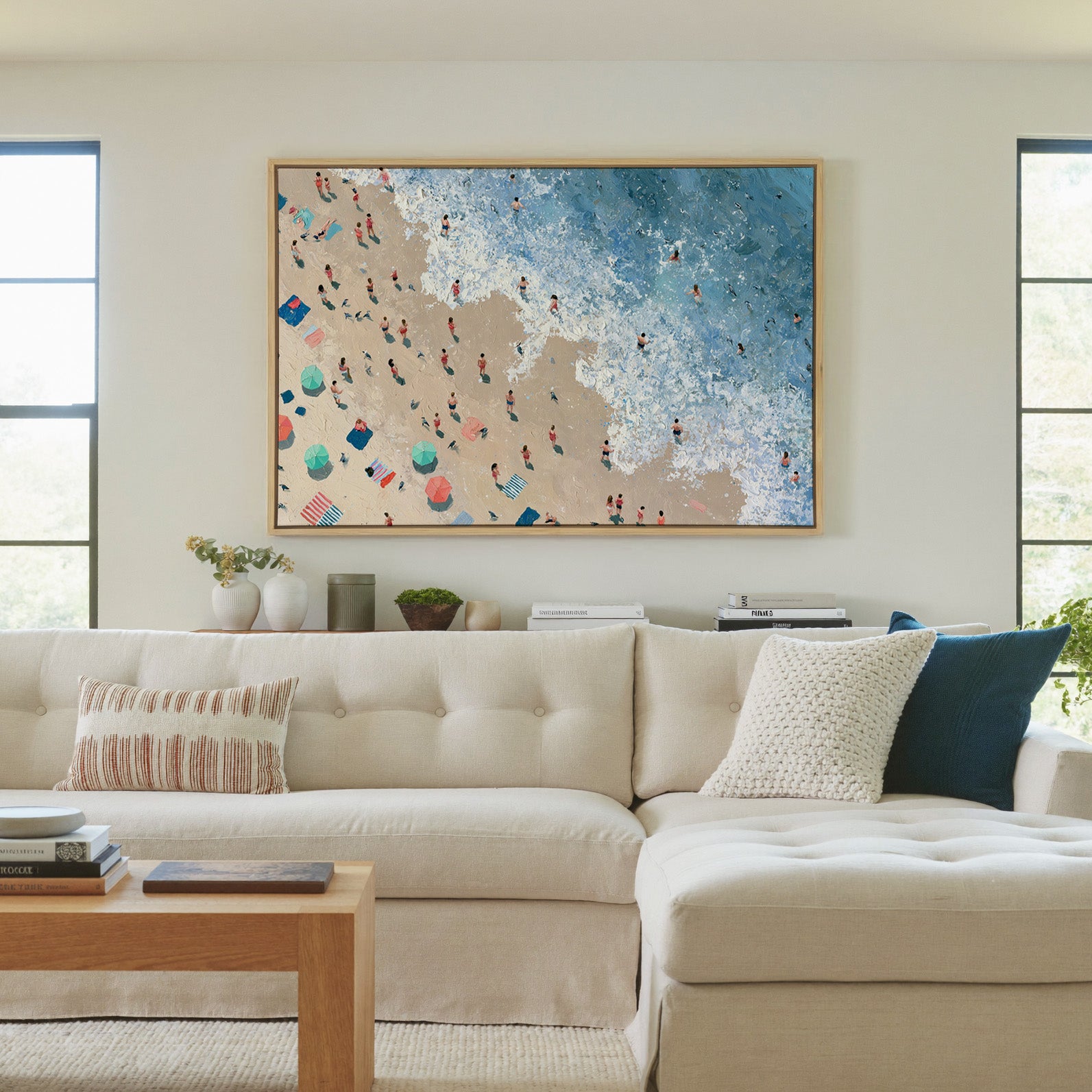 diagonal shoreline with swimmers and umbrellas canvas wall art in a natural wood frame in a living room
