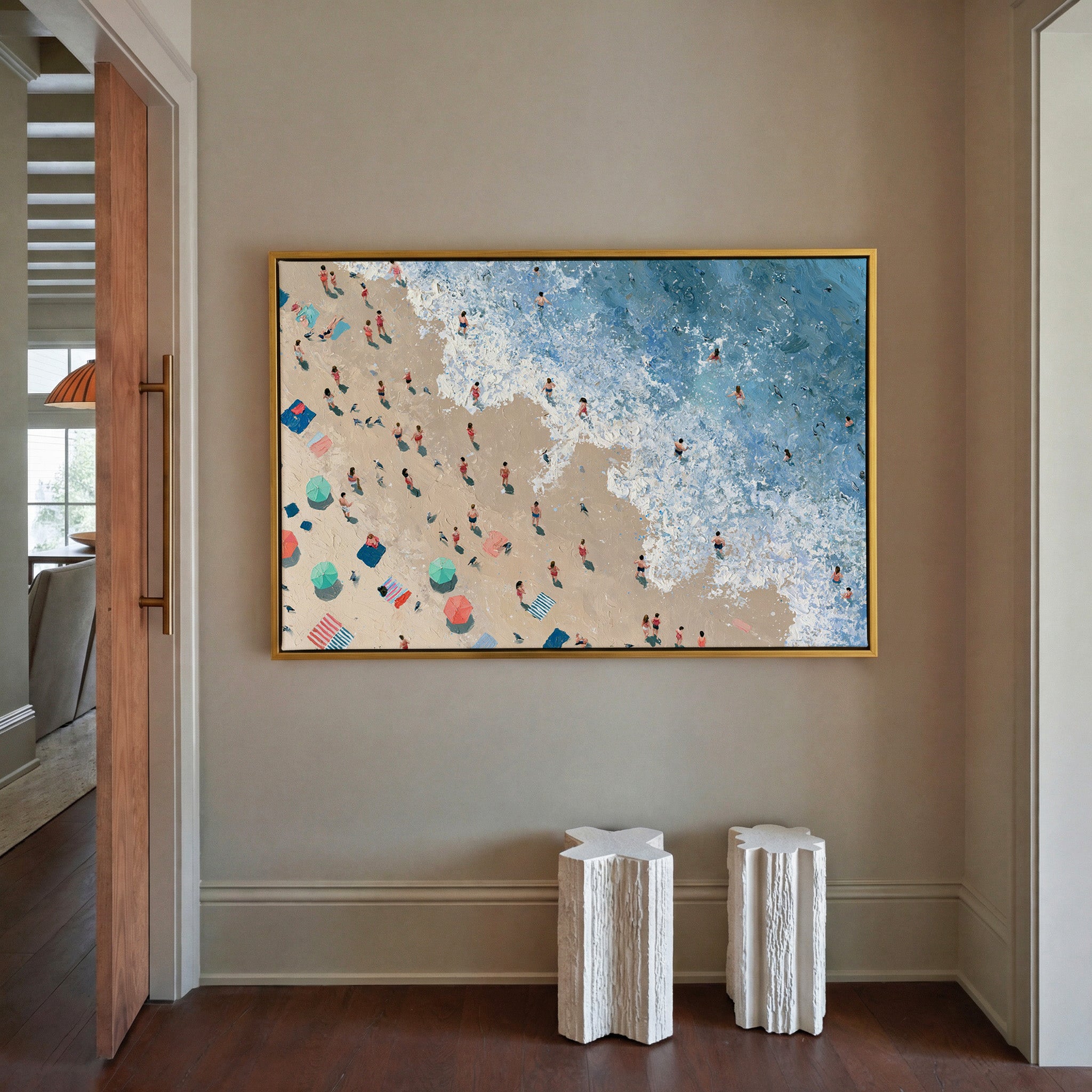 diagonal shoreline with swimmers and umbrellas canvas wall art in a gold frame in a styled room setting