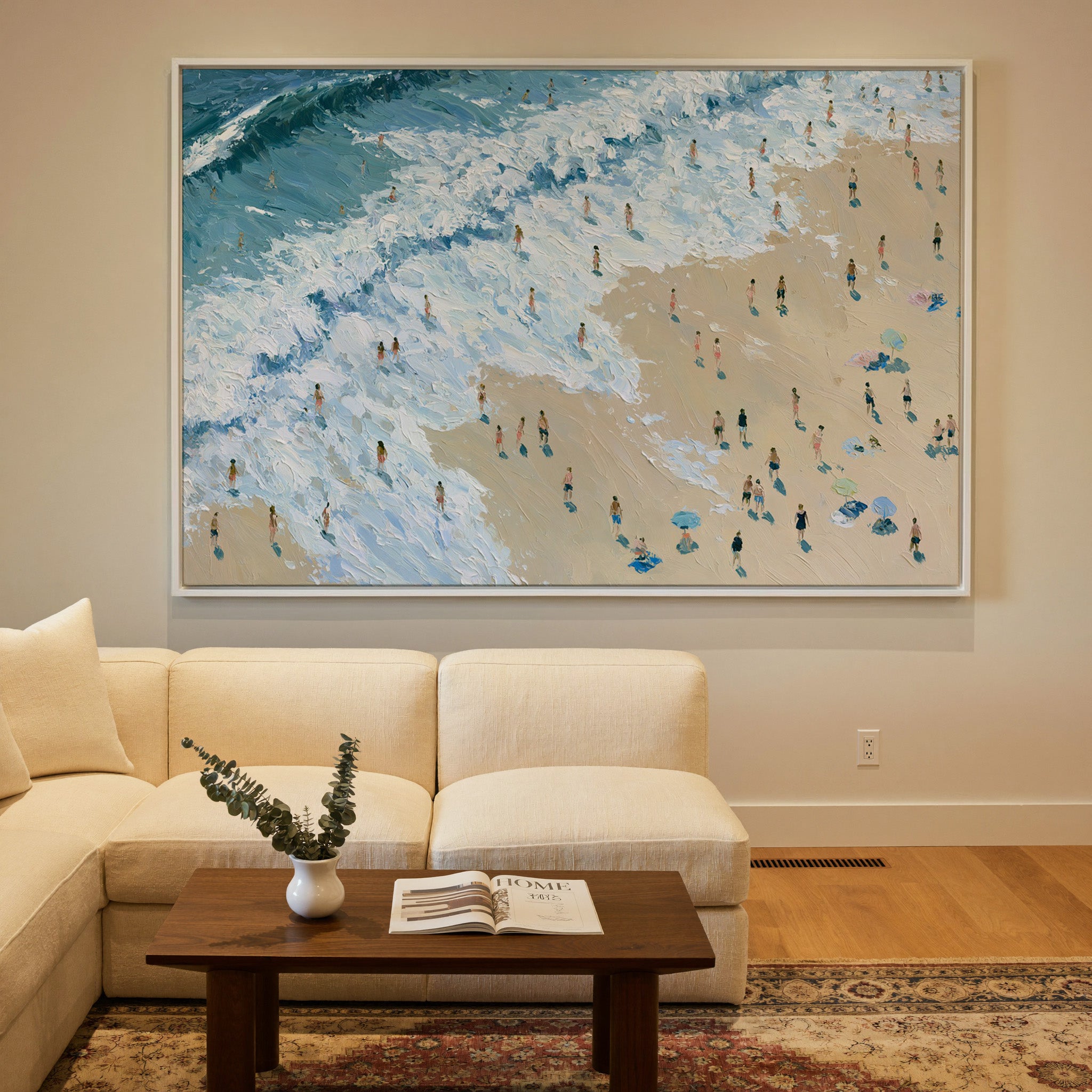 diagonal shoreline with white surf and small canvas wall art in a white frame in a styled room setting