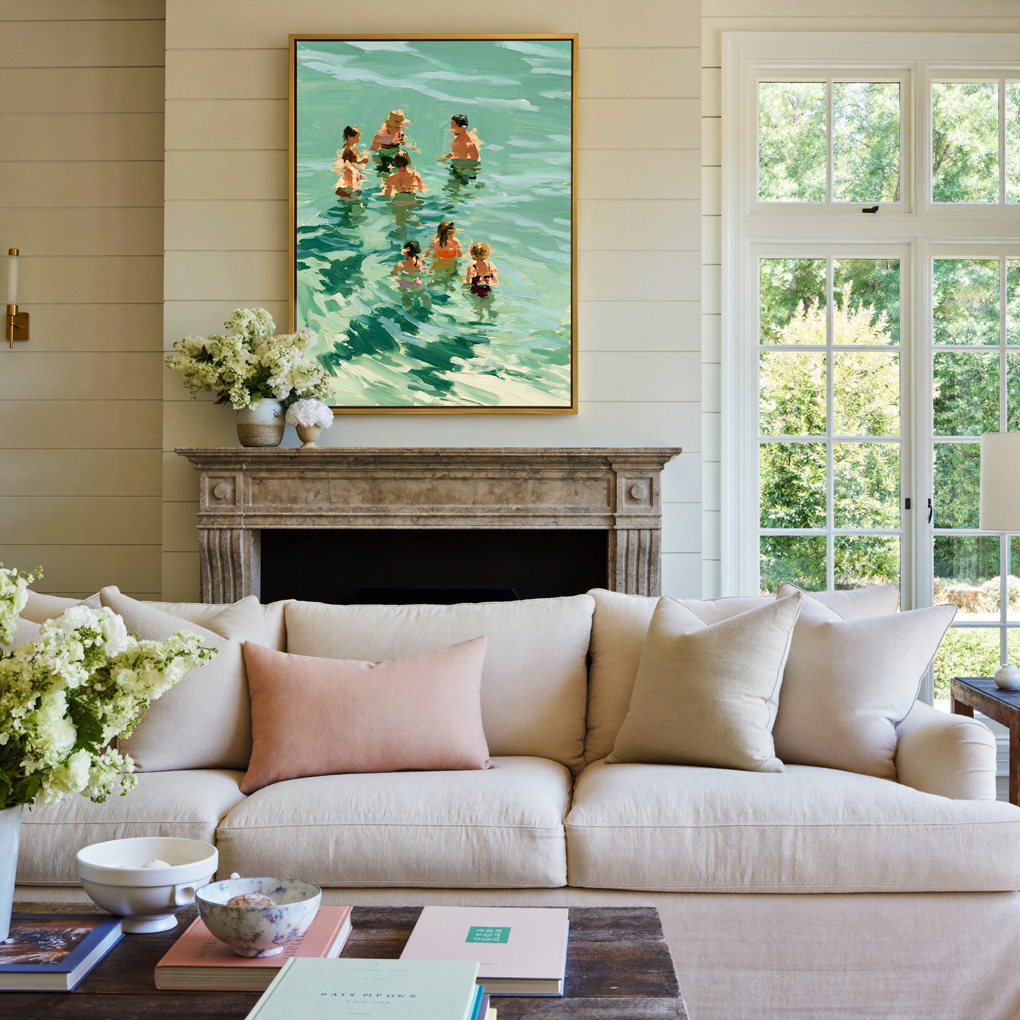 group of bathers in translucent green water canvas wall art in a gold frame above a mantel