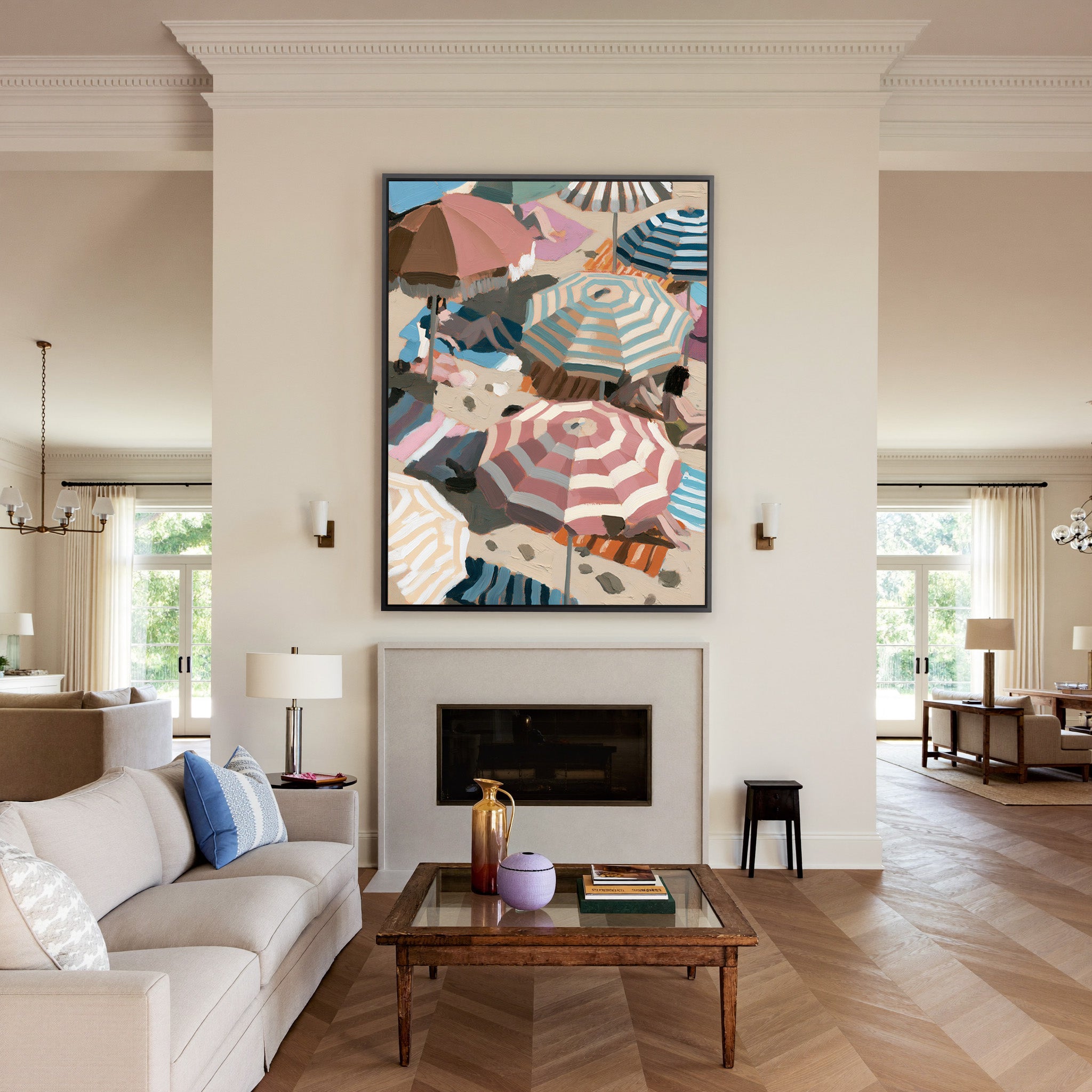 overlapping beach umbrellas in striped pink, canvas wall art in a black frame above a mantel