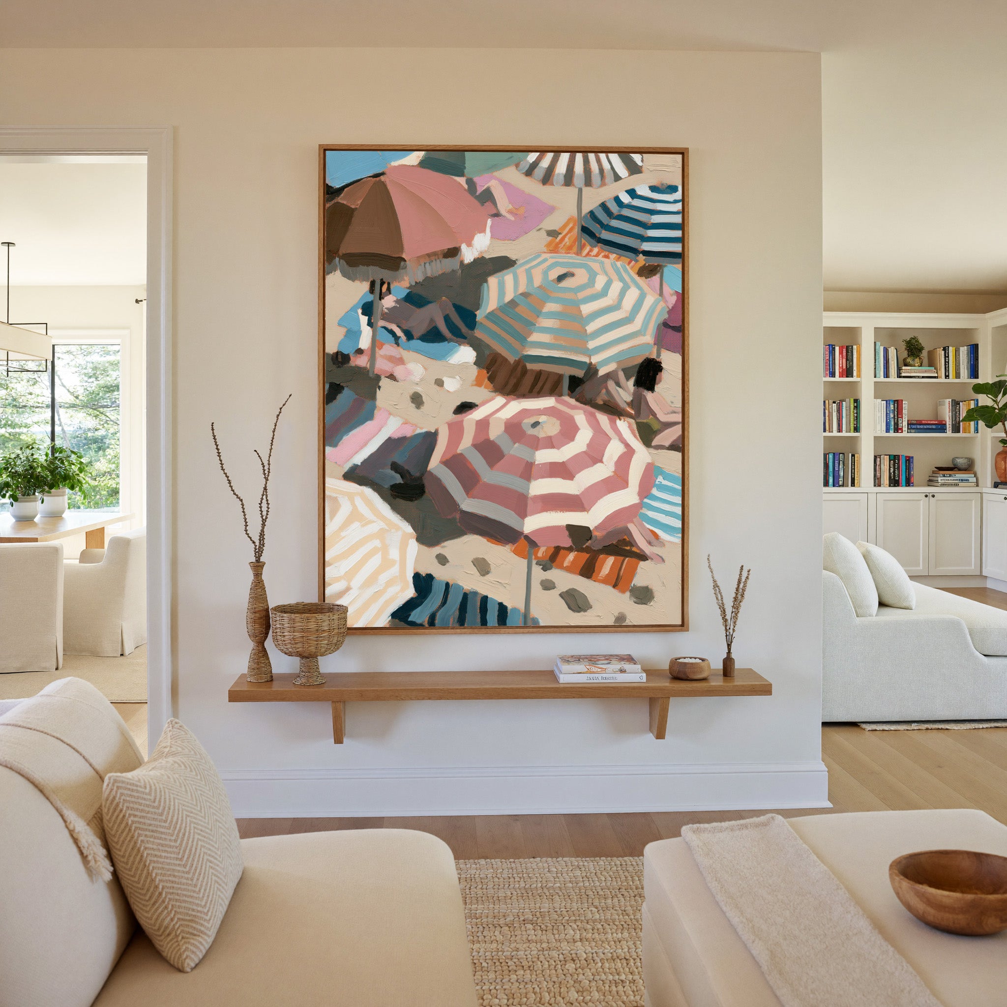 overlapping beach umbrellas in striped pink, canvas wall art in an oak frame in a living room