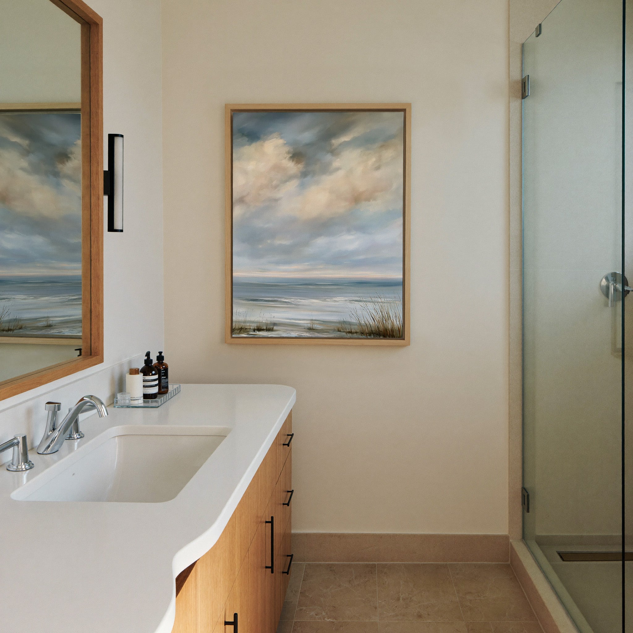 pale coastal horizon beneath broken clouds canvas wall art in a natural wood frame in a styled room setting