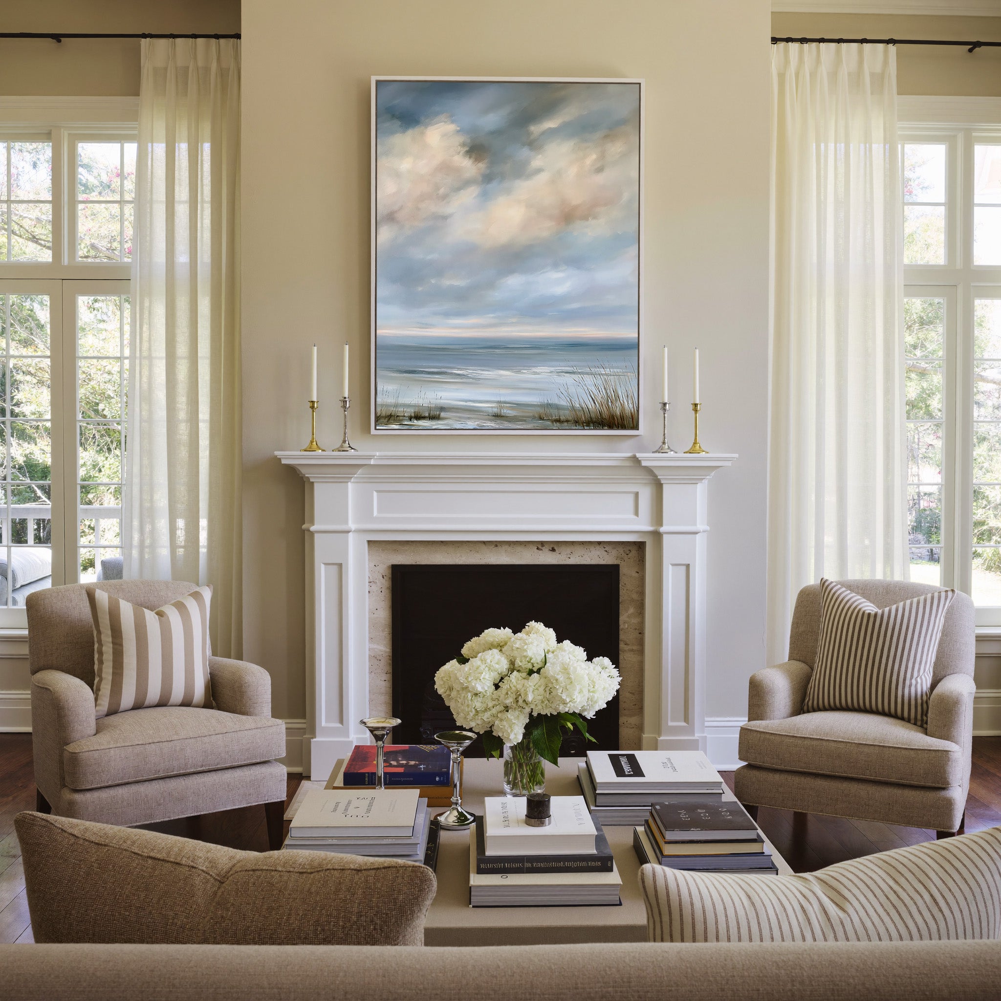 pale coastal horizon beneath broken clouds canvas wall art in a white frame above a mantel