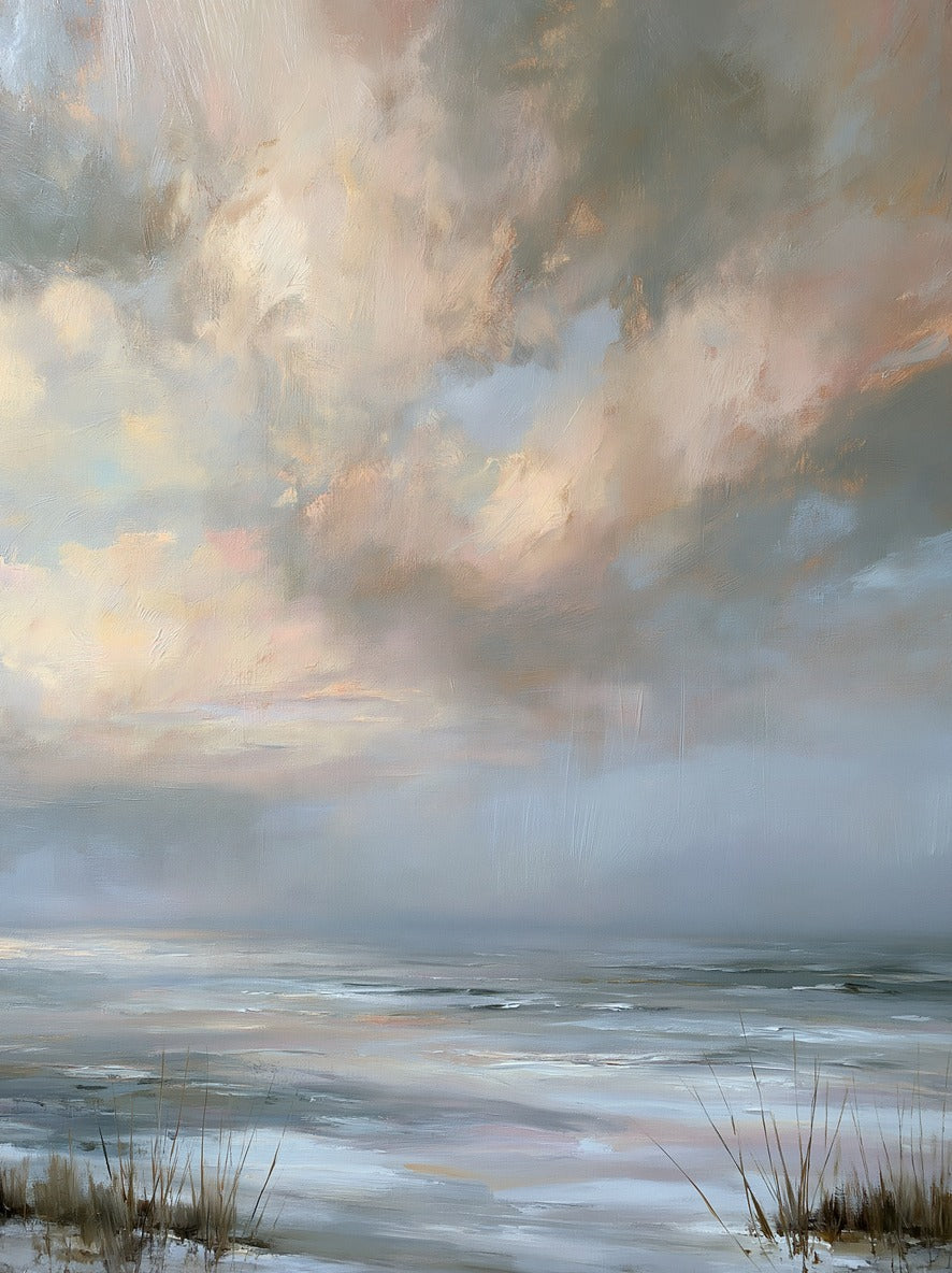 Broken clouds over a pale coastal horizon with silvery water and grasses at the lower edge