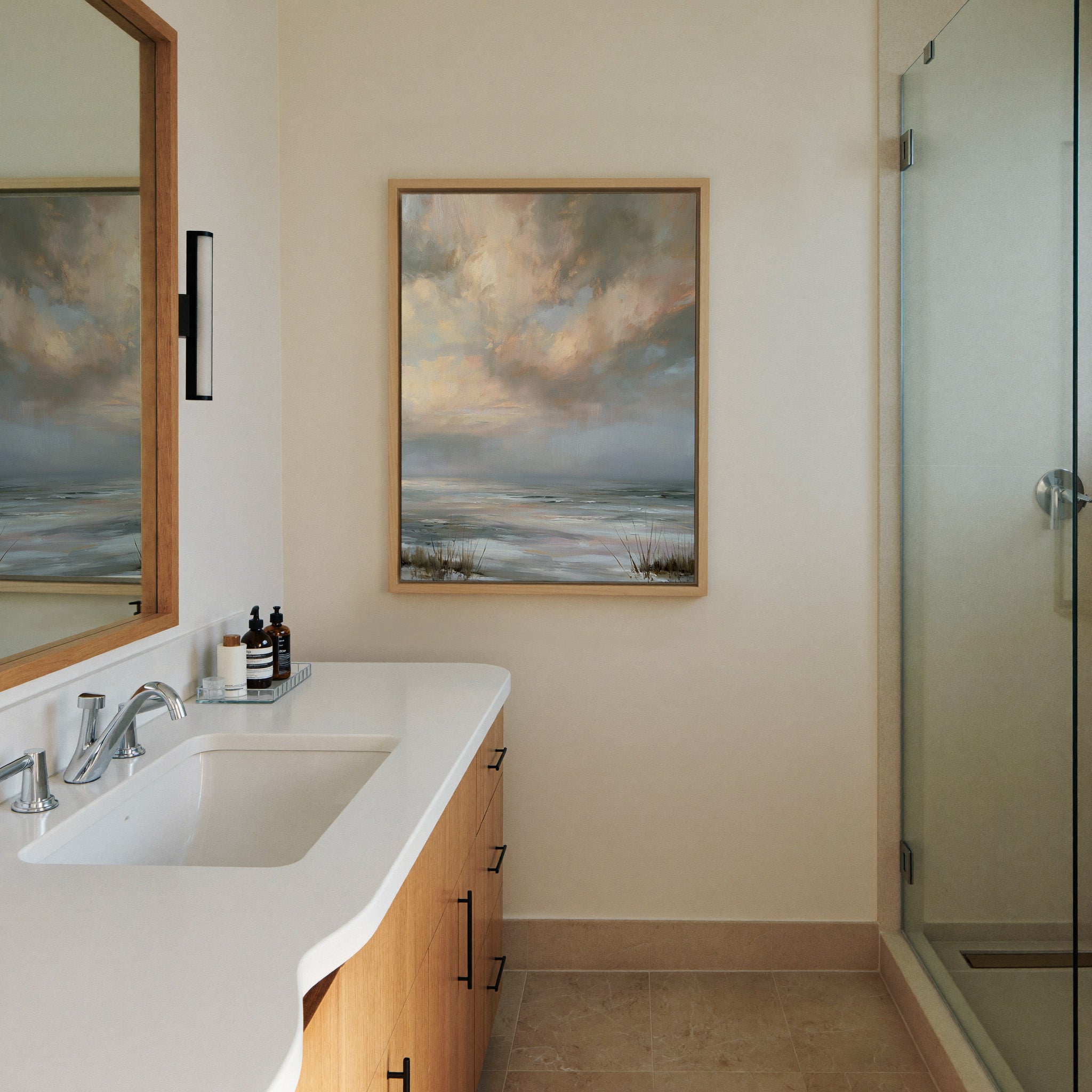pale coastal horizon beneath broken clouds canvas wall art in a natural wood frame in a styled room setting