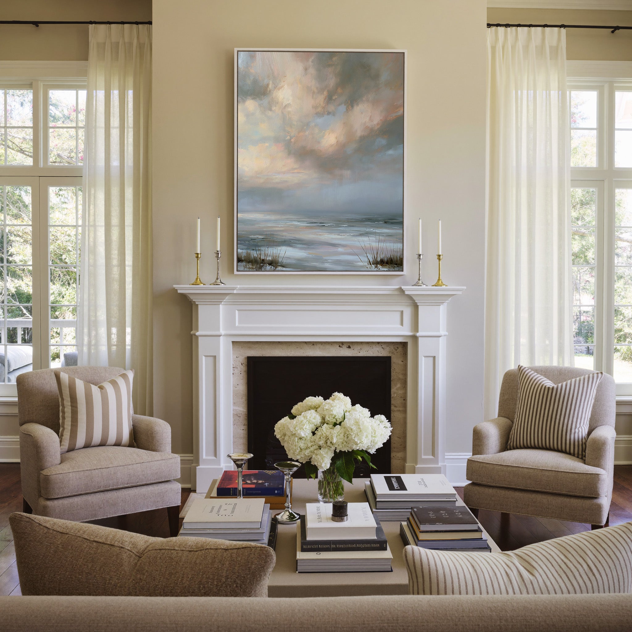 pale coastal horizon beneath broken clouds canvas wall art in a white frame above a mantel