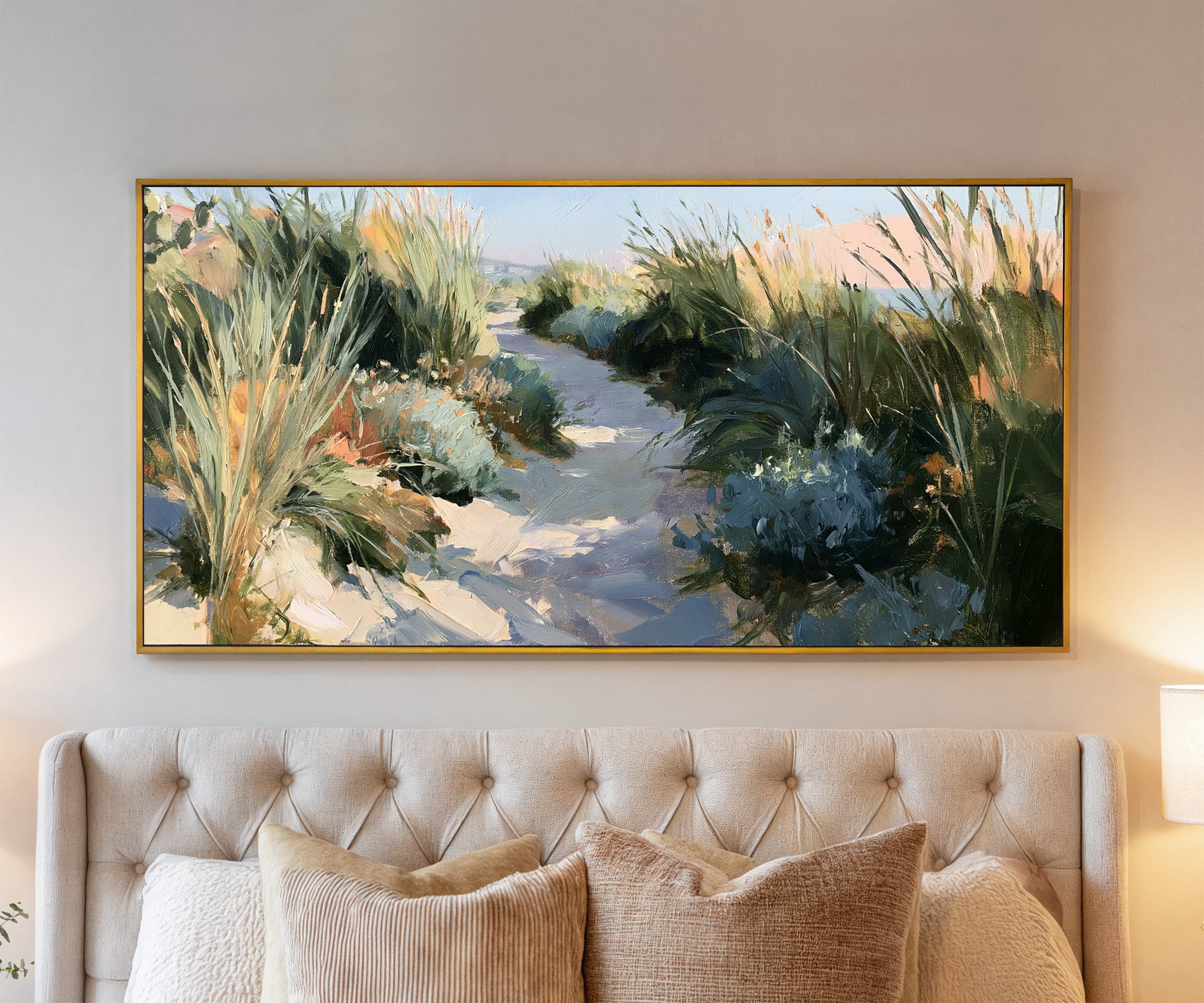 sandy path between tall coastal grasses canvas wall art in a gold frame above a bed