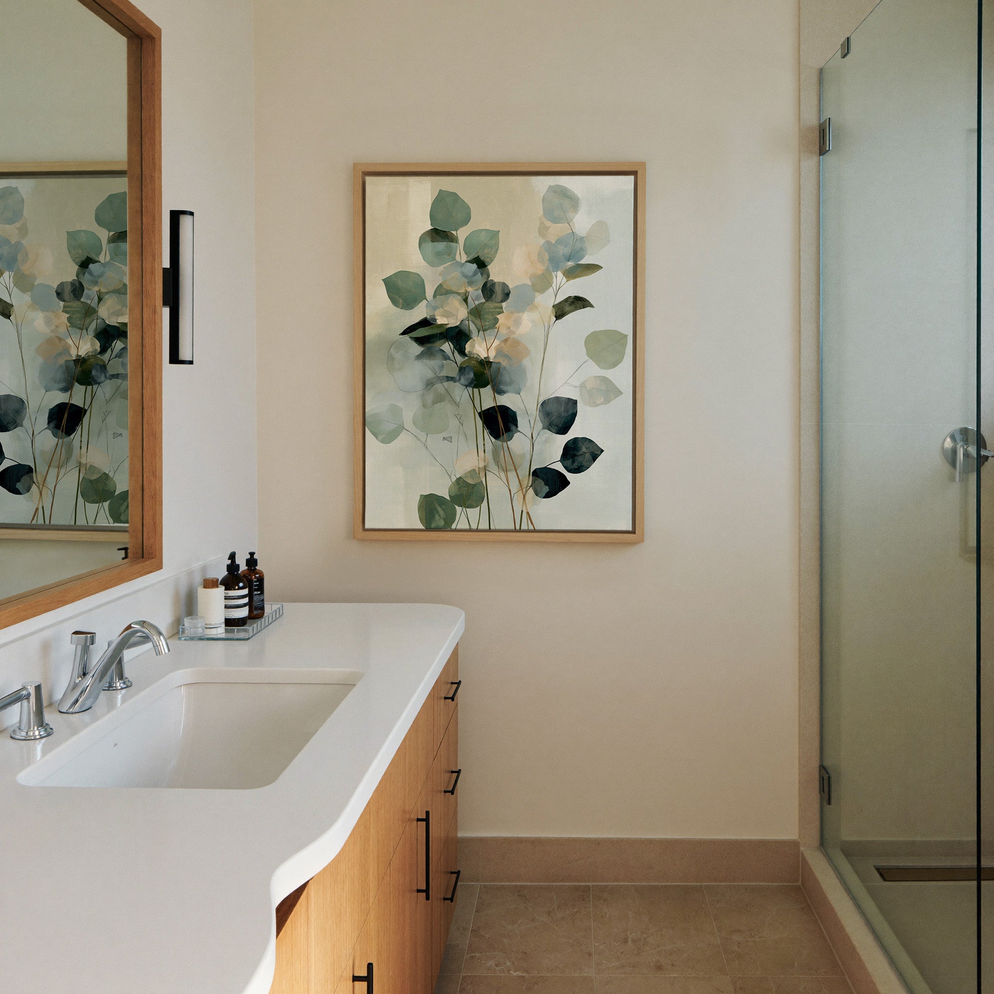 soft eucalyptus like leaves in blue green and canvas wall art in a natural wood frame in a styled room setting